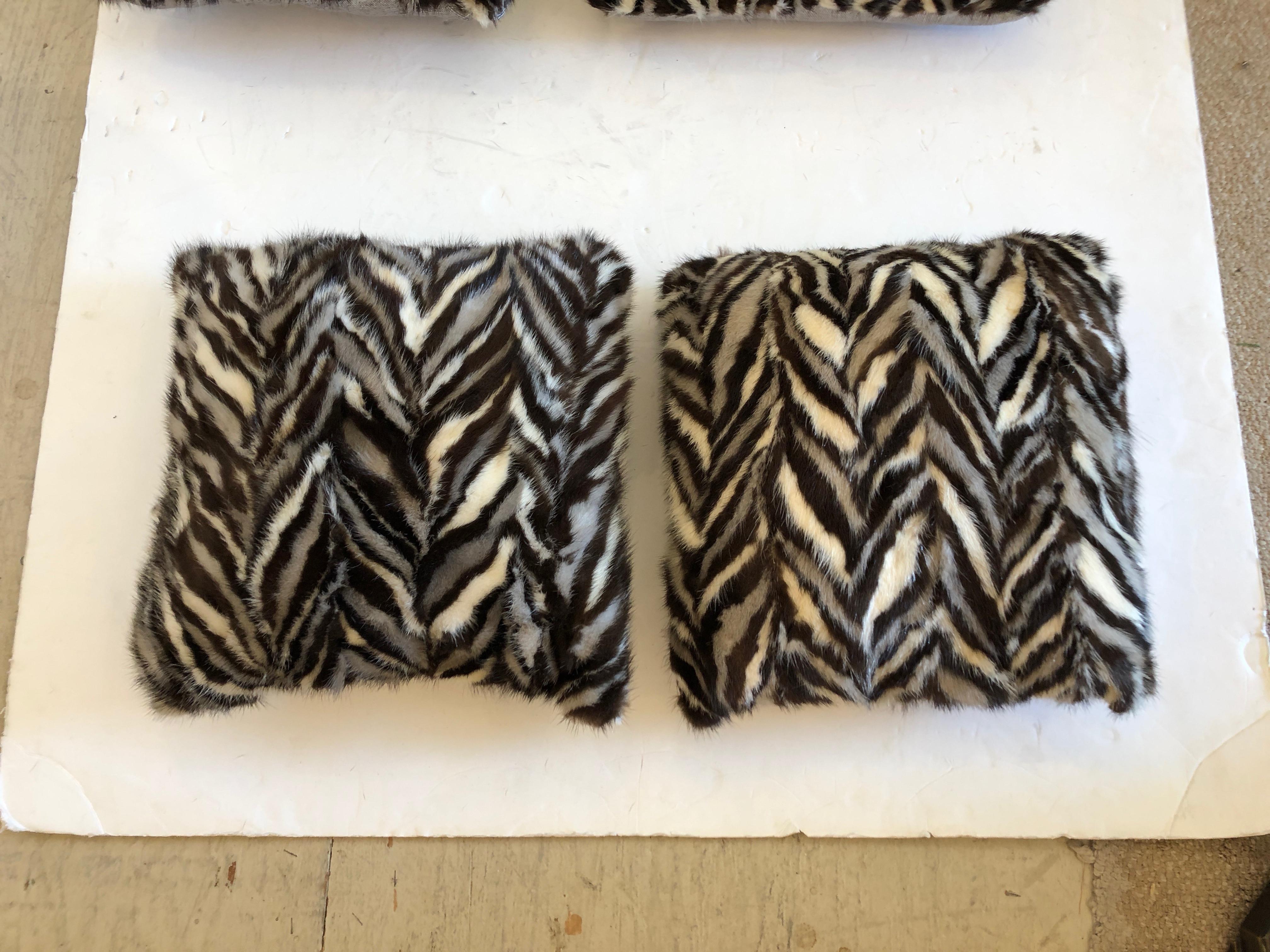 A collection of one of a kind mink pillows having a graphic black, white and grey zig zaggy pattern with platinum colored linen backs. One pair slightly smaller than the other pair.
Smaller set are 13 inches square; larger 14 inches square
Note: