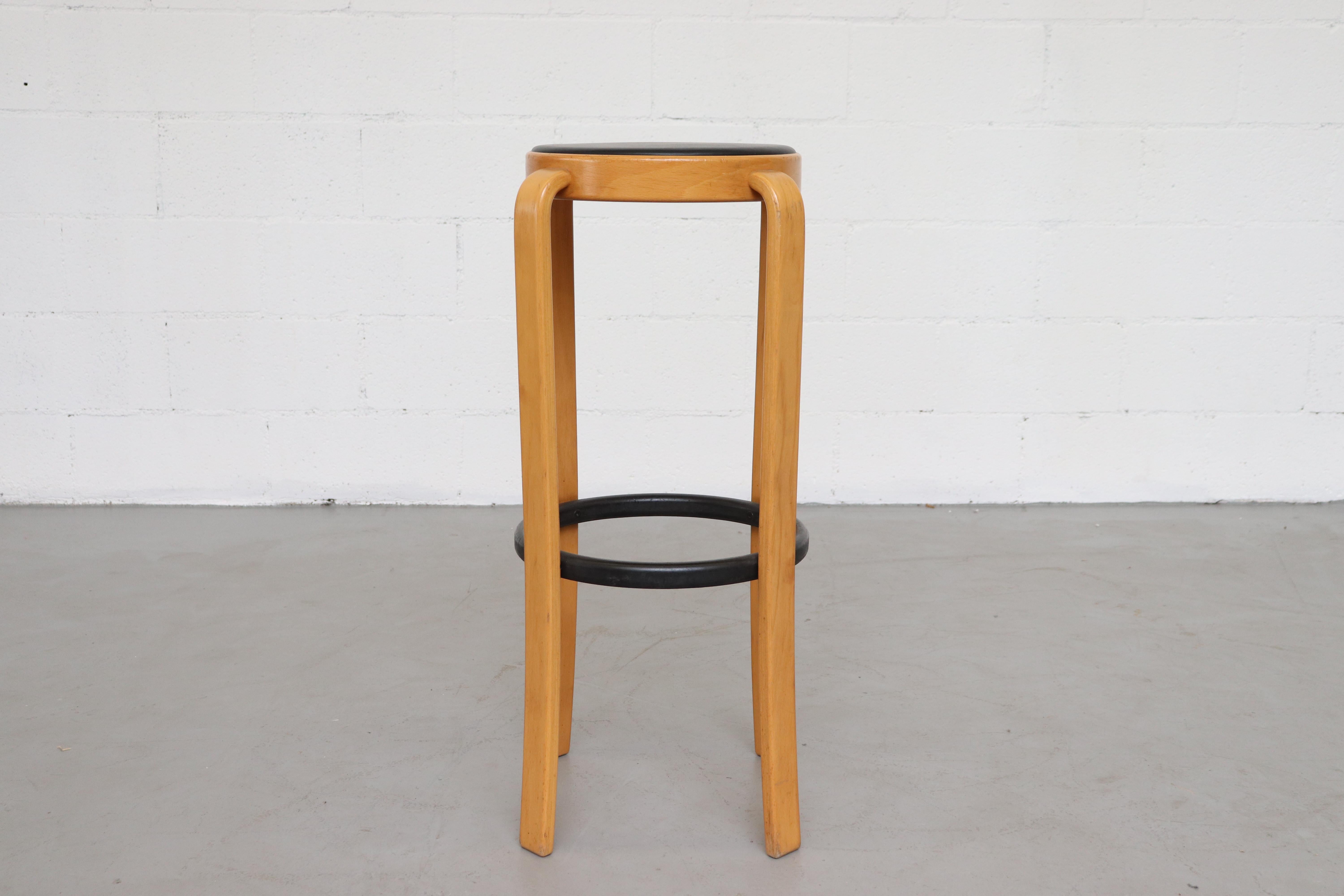 Birch bent wood legged bar stools with ebony foot rests and newly upholstered black leather seats. Set price.