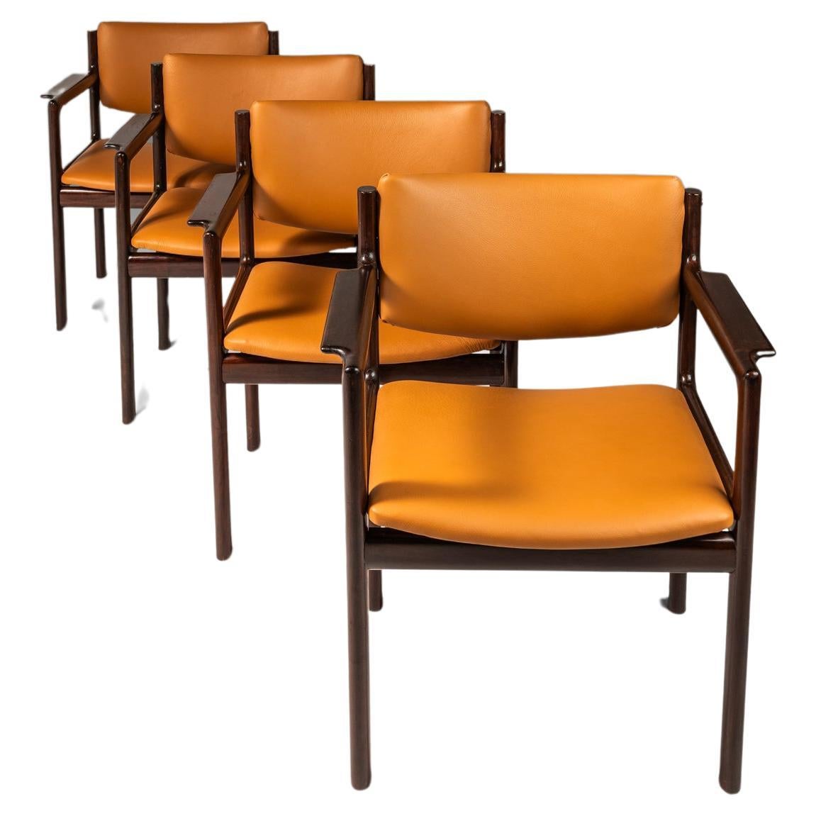 Set of 4 Mahogany Arm Chairs, Caramel Leather by Danish Overseas Imports, 1960's For Sale