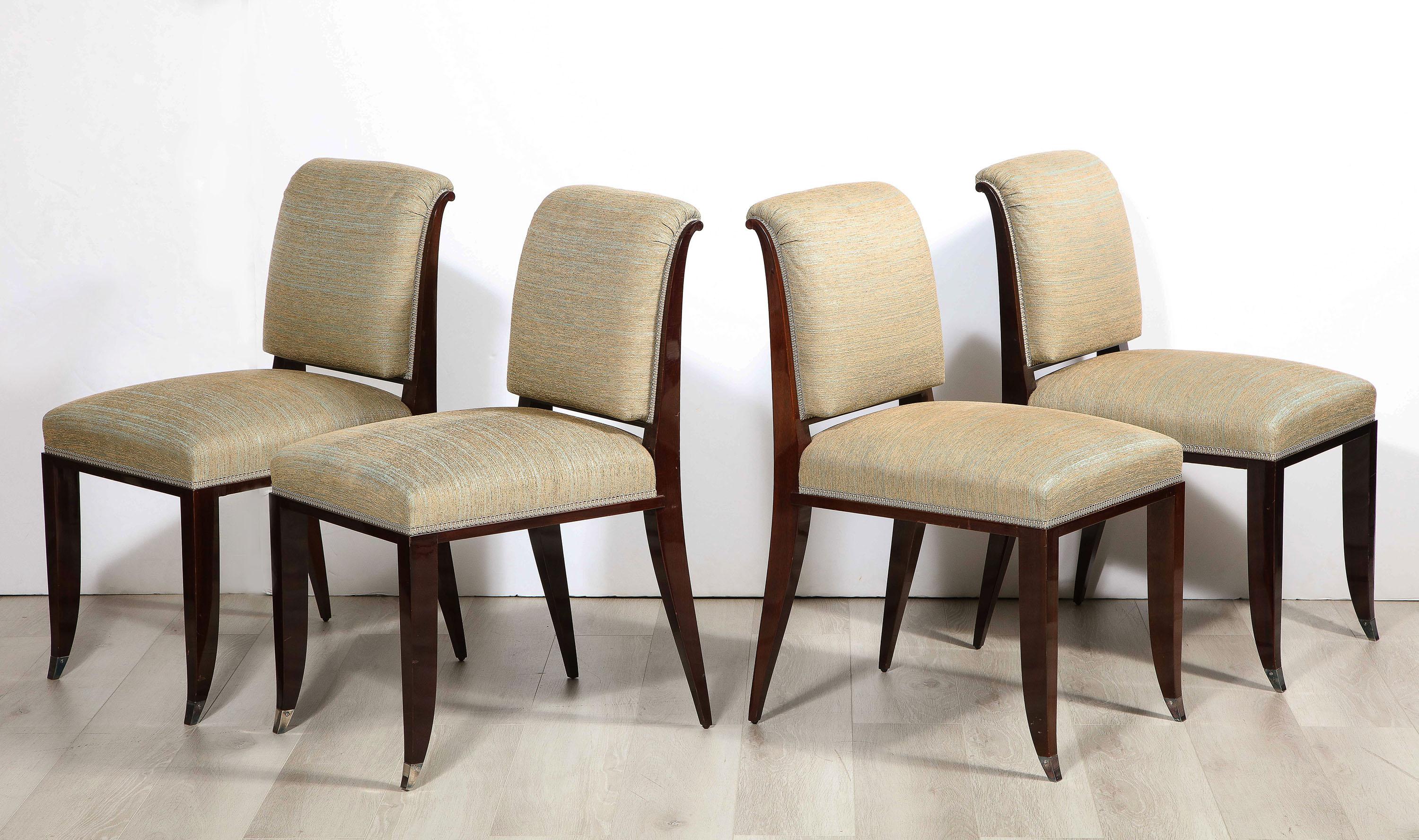 The four mahogany side chairs each with nickel sabots.