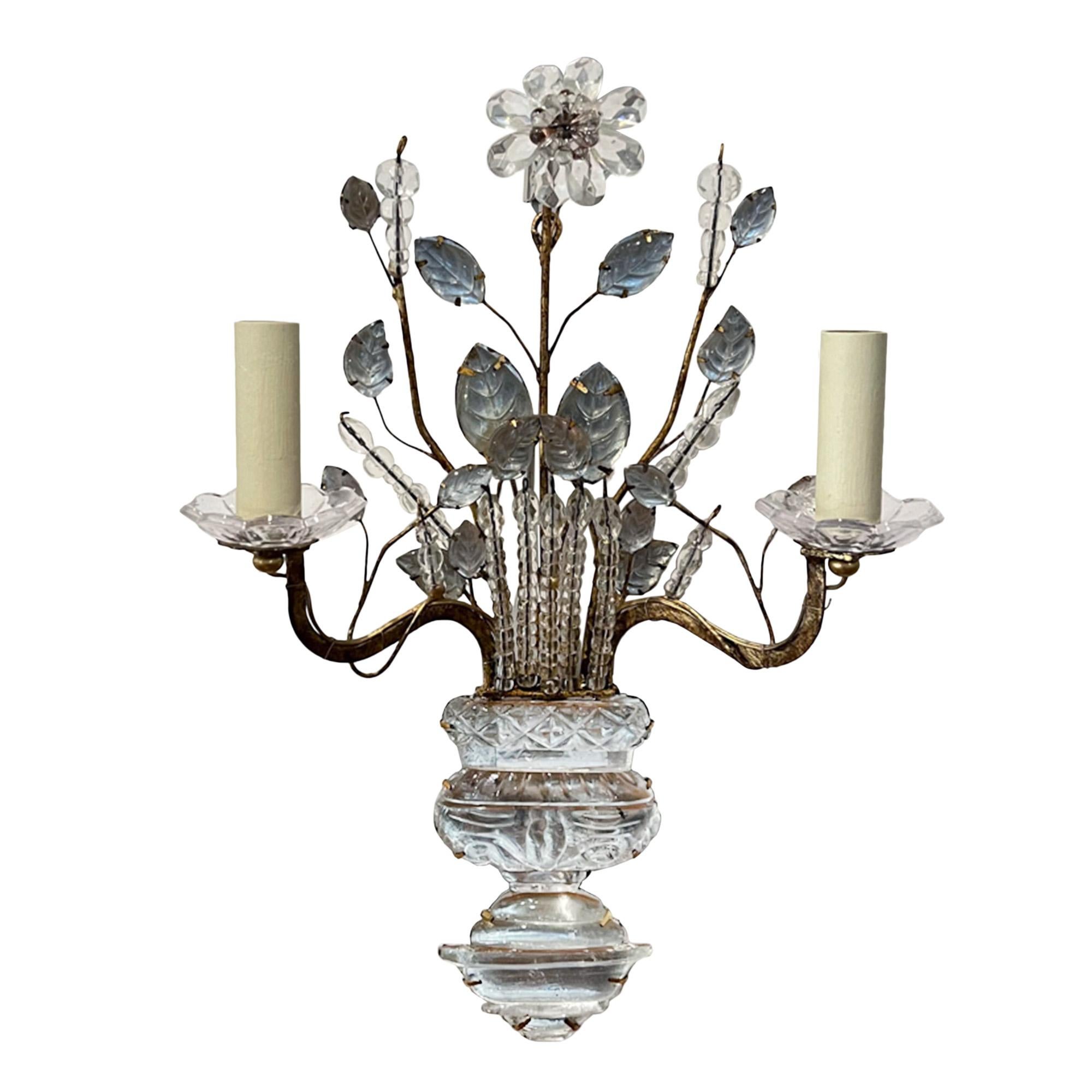A beautiful set of four wall sconces made in the style of Maison Baguès in France in the 1960s. 

Hand crafted with gilt metal and glass, these wall lights are highly decorative with intricate detail of flowers, leaves and urns. 

We've wired these