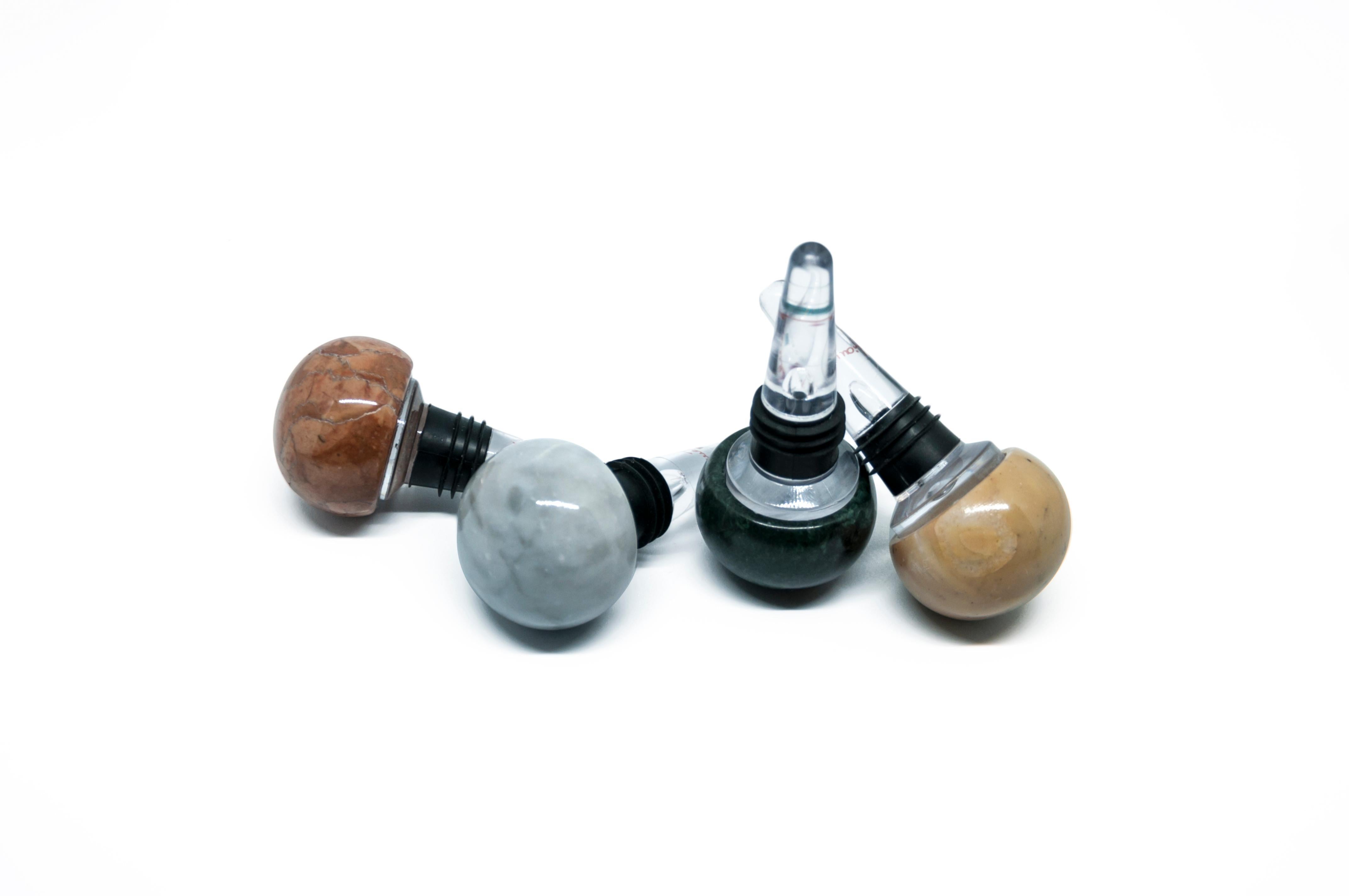 Set of 4 bottle stoppers in mixed marble colors and plexiglass, ideal for Champagne glass bottles.

Each piece is in a way unique (since each marble block is different in veins and shades) and handcrafted in Italy. Slight variations in shape, color