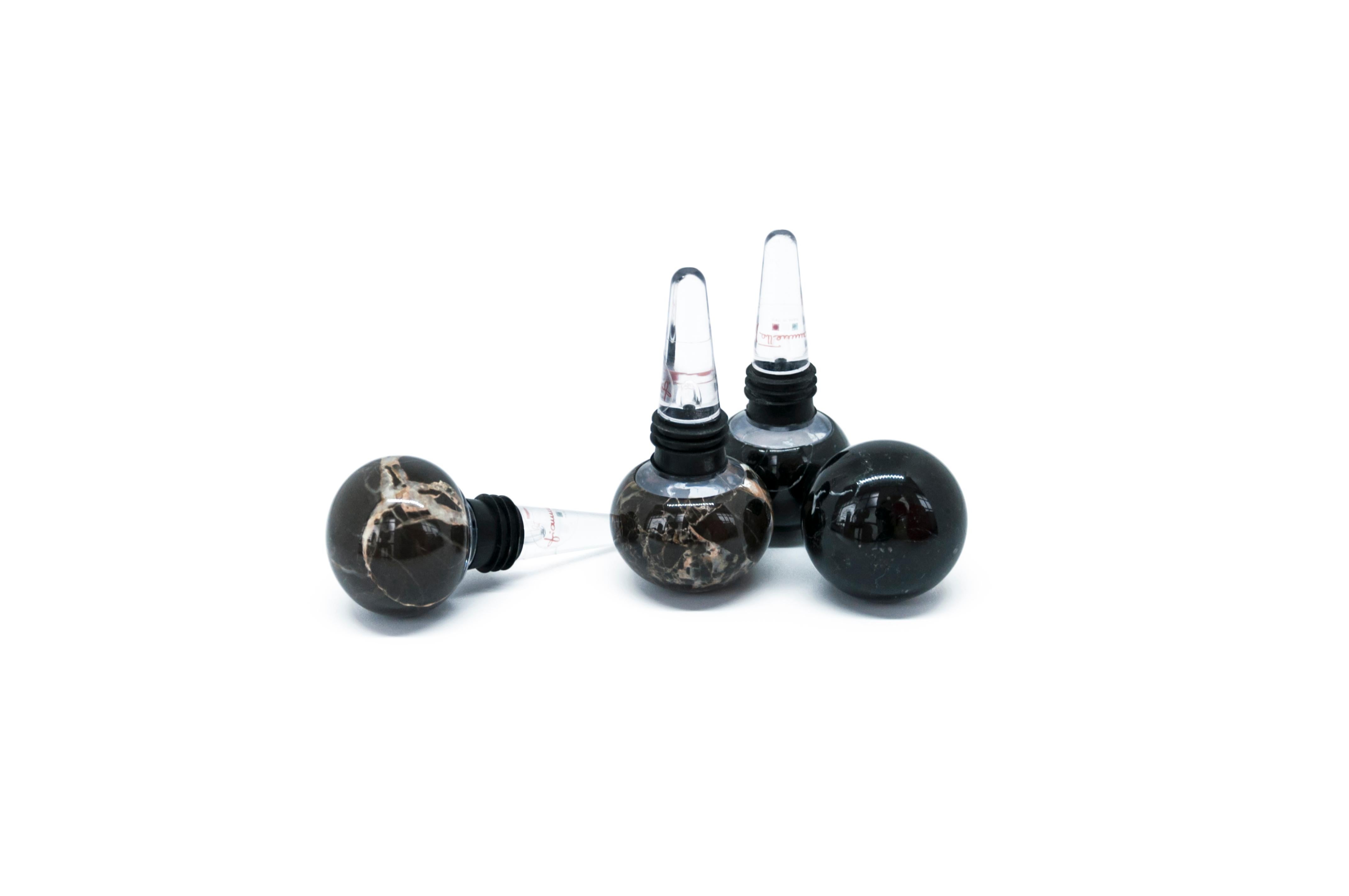 Set of 4 bottle stoppers (2 in black Marquina marble and 2 in Portoro marble + plexiglass), ideal for Champagne glass bottles.

Each piece is in a way unique (since each marble block is different in veins and shades) and handcrafted in Italy. Slight