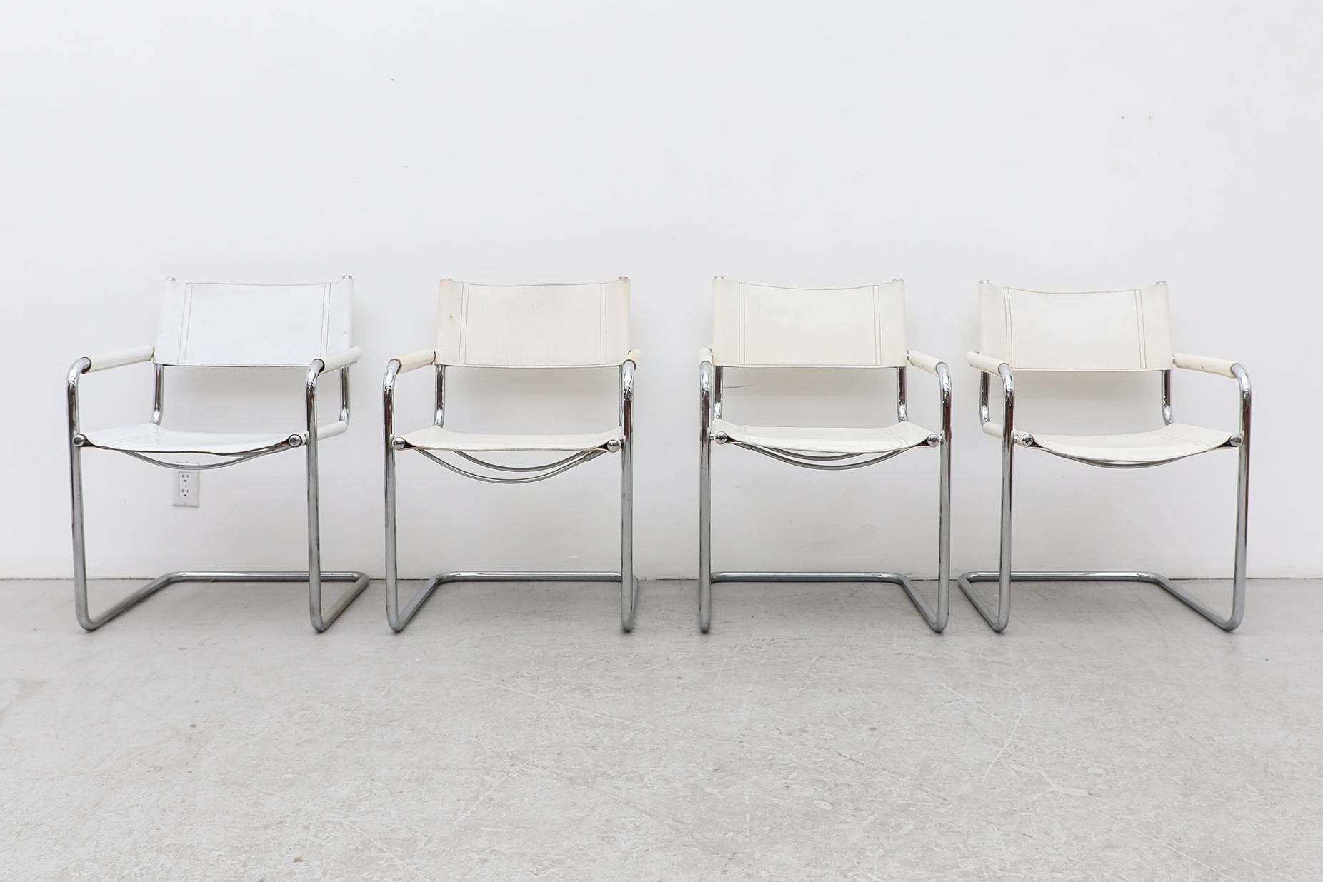 Set of 4 Marcel Breuer style white leather cantilevered chairs with leather wrapped armrests and tubular chrome frames. Inspired by Breuer's iconic D 40 chairs, designed in 1928. One chair is bright white and the other 3 are more off-white. Each