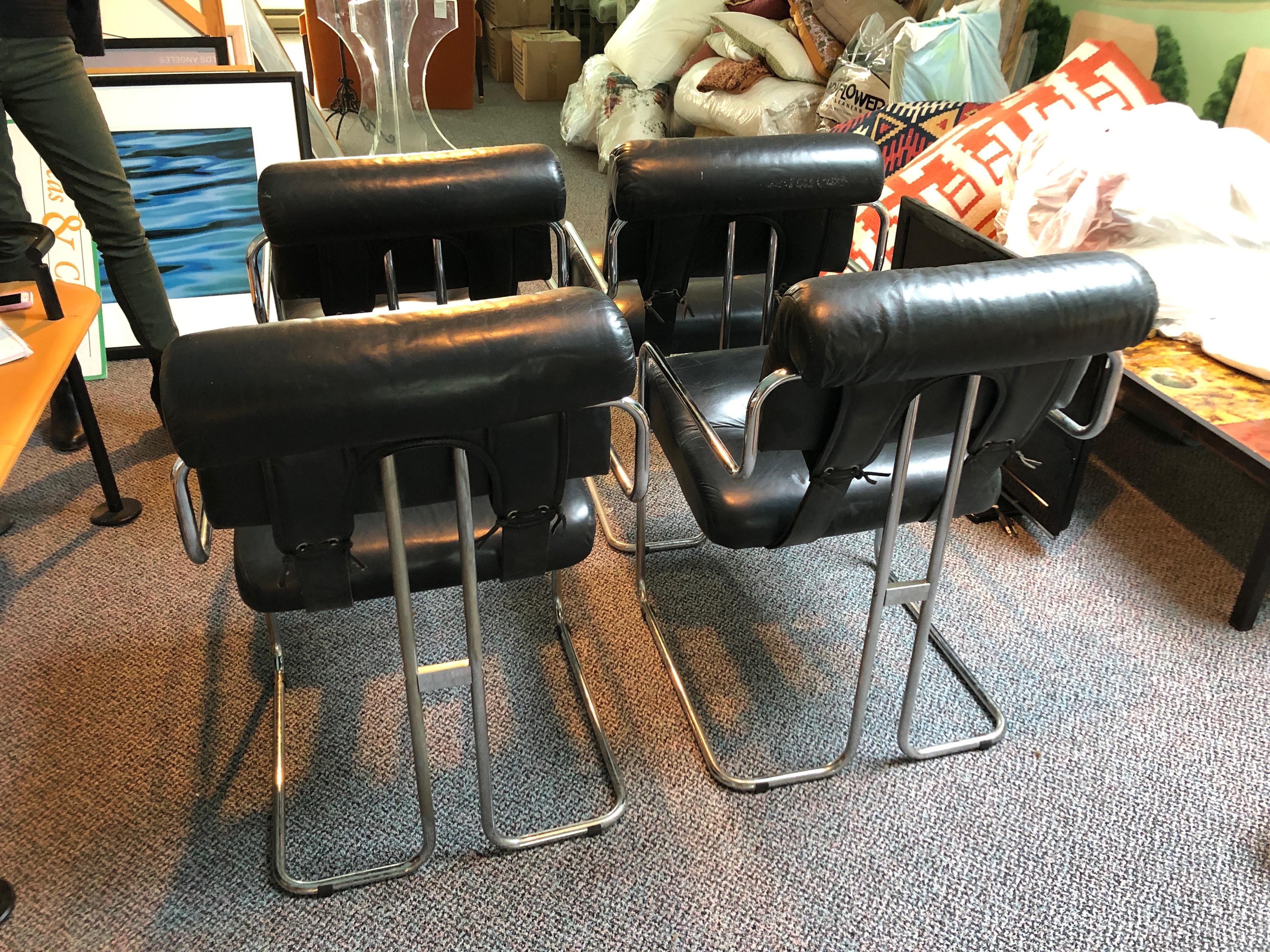 A fabulous mid century modern set of four Tucroma dining chairs by i4 Mariani for The Pace collection. Designed by Guido Faleschini in 1972, each chair is constructed from bent steel tubing and upholstered in sexy rich black leather. Seats are