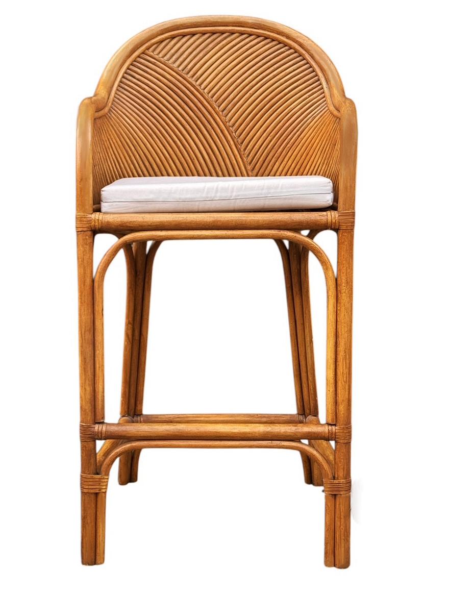 A vintage set of rattan / bamboo barstools circa mid 1980's. These bar stools feature rattan framing with upholstered seats. Fabric cushions are original so recovering is recommended but very usable as is. 