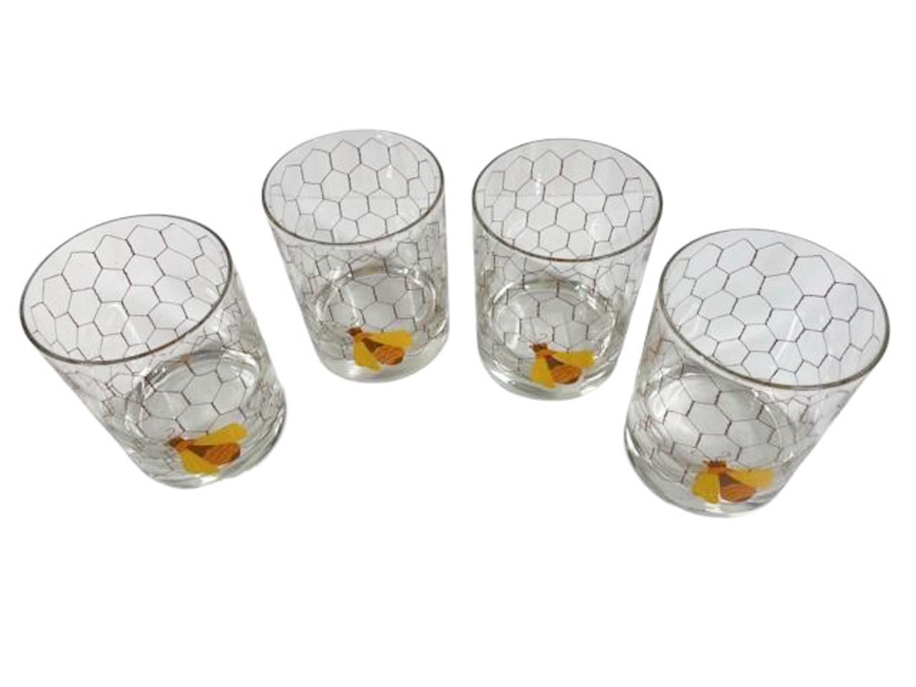 Set of four Cera Glassware rocks glasses with enameled honeybee on wire screening in yellow, orange and tan enamels.