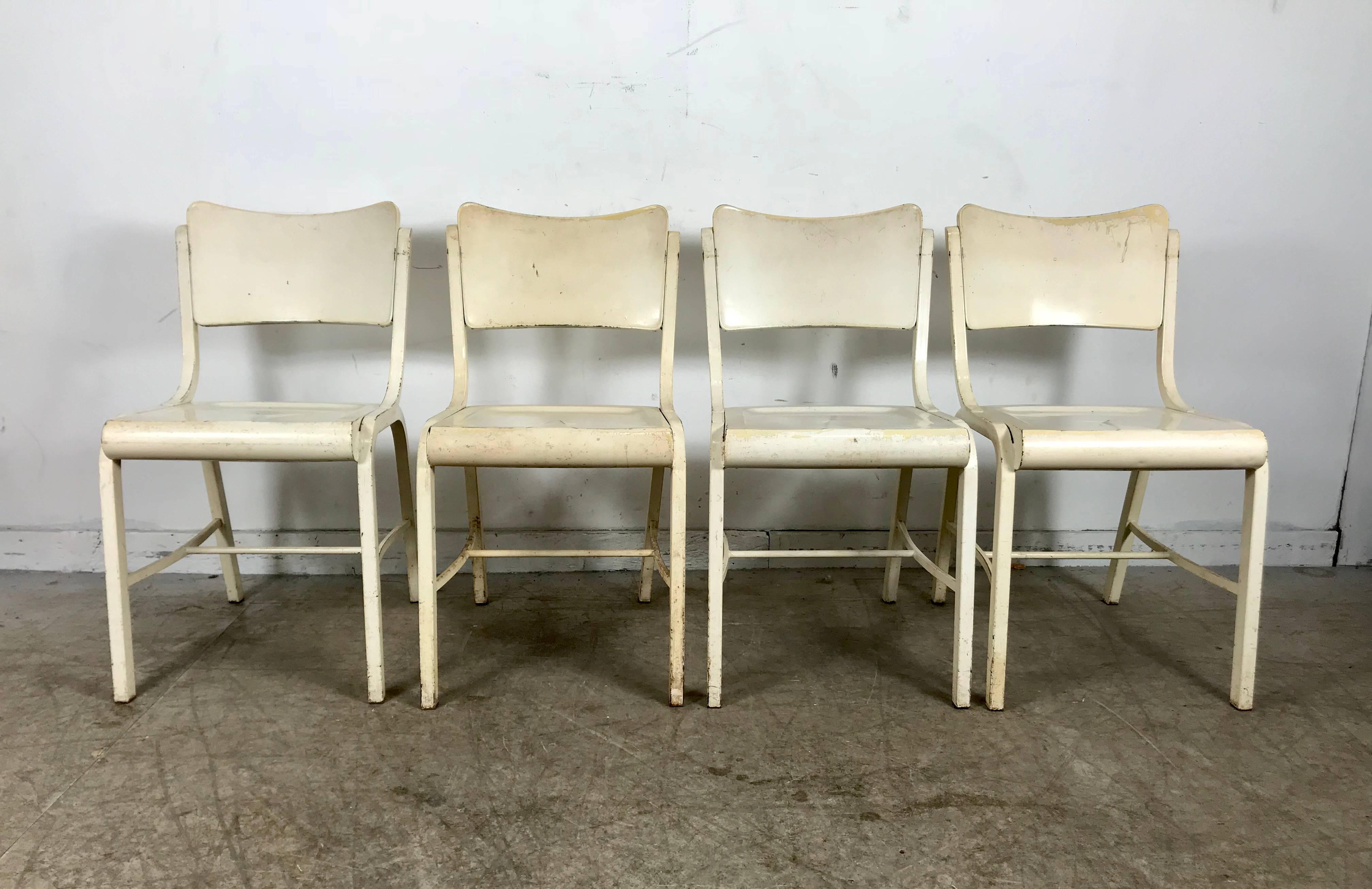 Set of four metal industrial side chairs manufactured by Doehler Metal Furn. Classic Art Deco period cafe chairs, retain original white painted finish, industrial yet elegant.