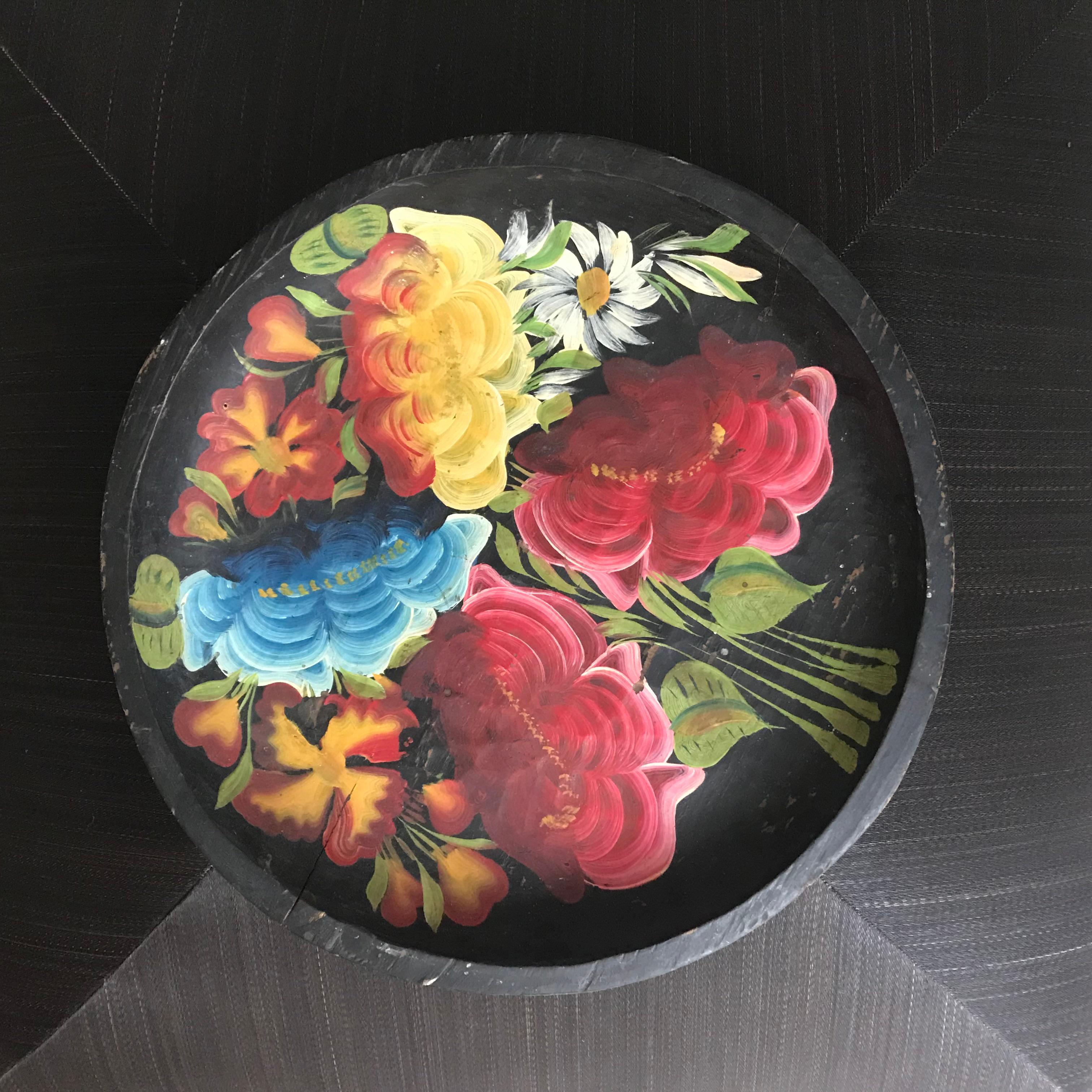 A set of 4 beautifully crafted Mexican wooden plates featuring black bases and vibrant hand-painted flowers. These pieces combine traditional craftsmanship with colorful artistry, perfect for adding a cultural touch to any space. Plate sizes: