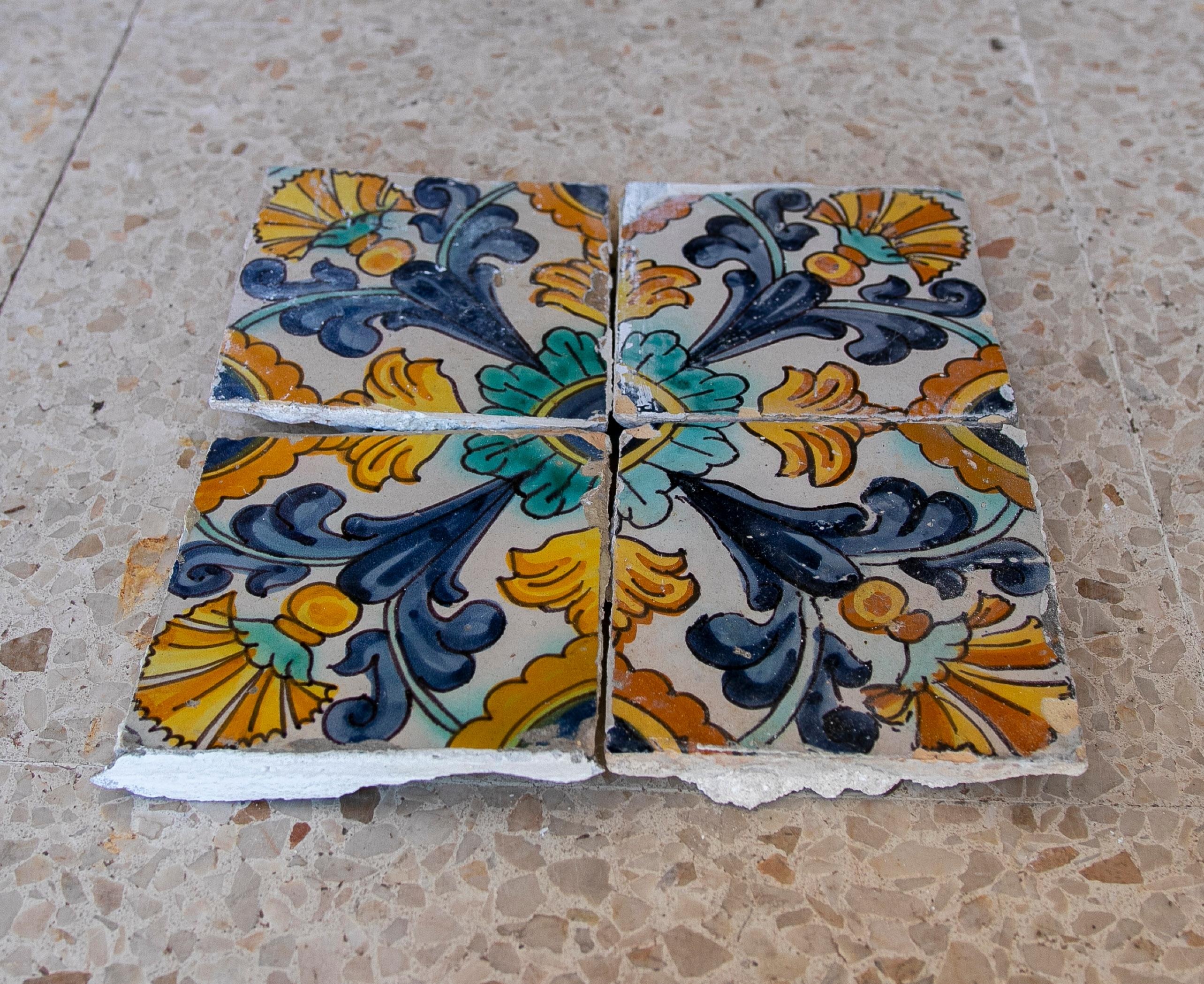 Set of 4 antique 1850s Spanish hand painted patterned glazed ceramic tiles.