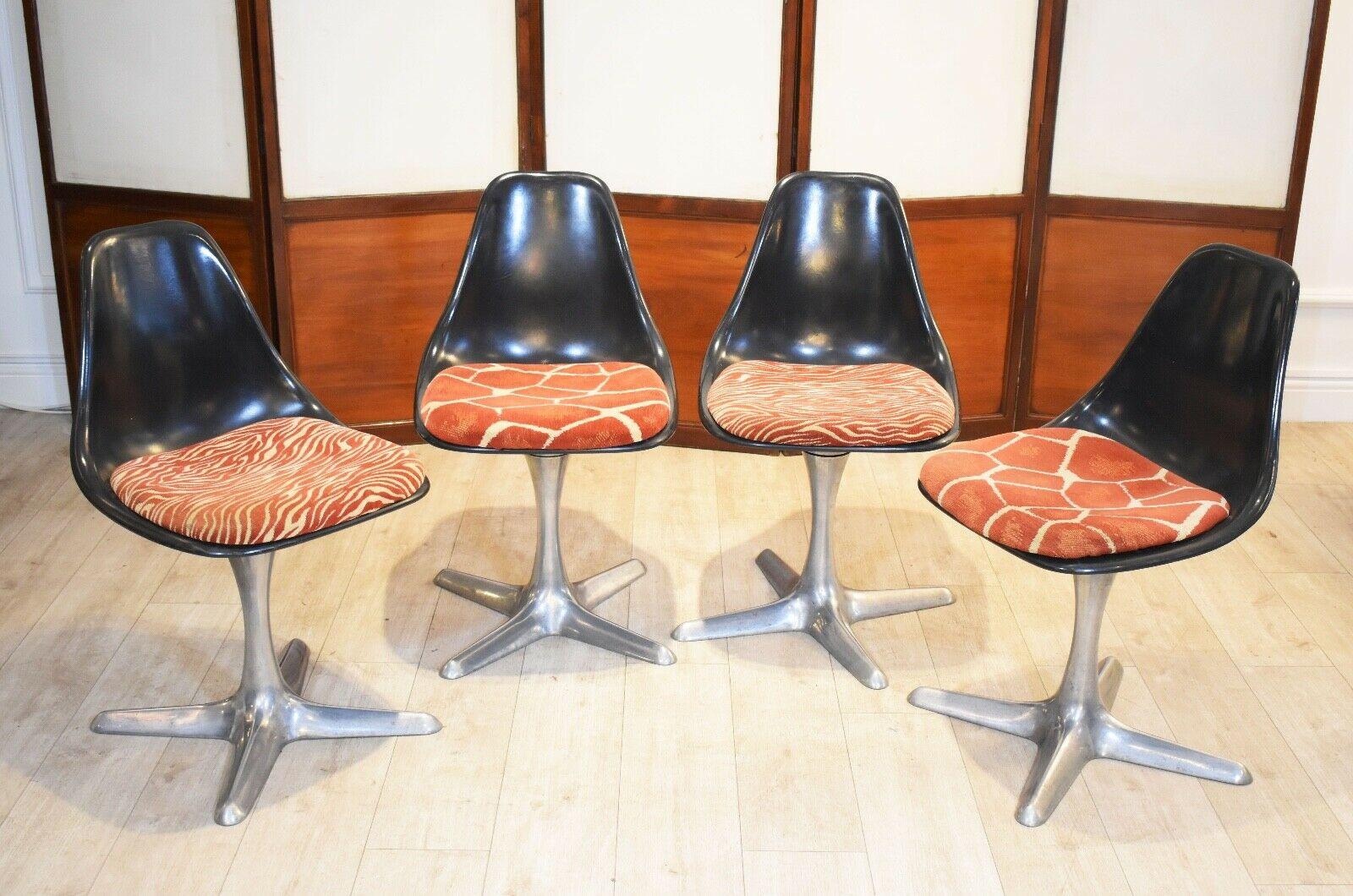Set of 4 mid-20th century dining chairs designed by Maurice Burke for Arkana

In their original animal print seat cushions. The chairs comprise of a black plastic shell and set on aluminium bases with swivel mechanism. 
Iconic space age design,