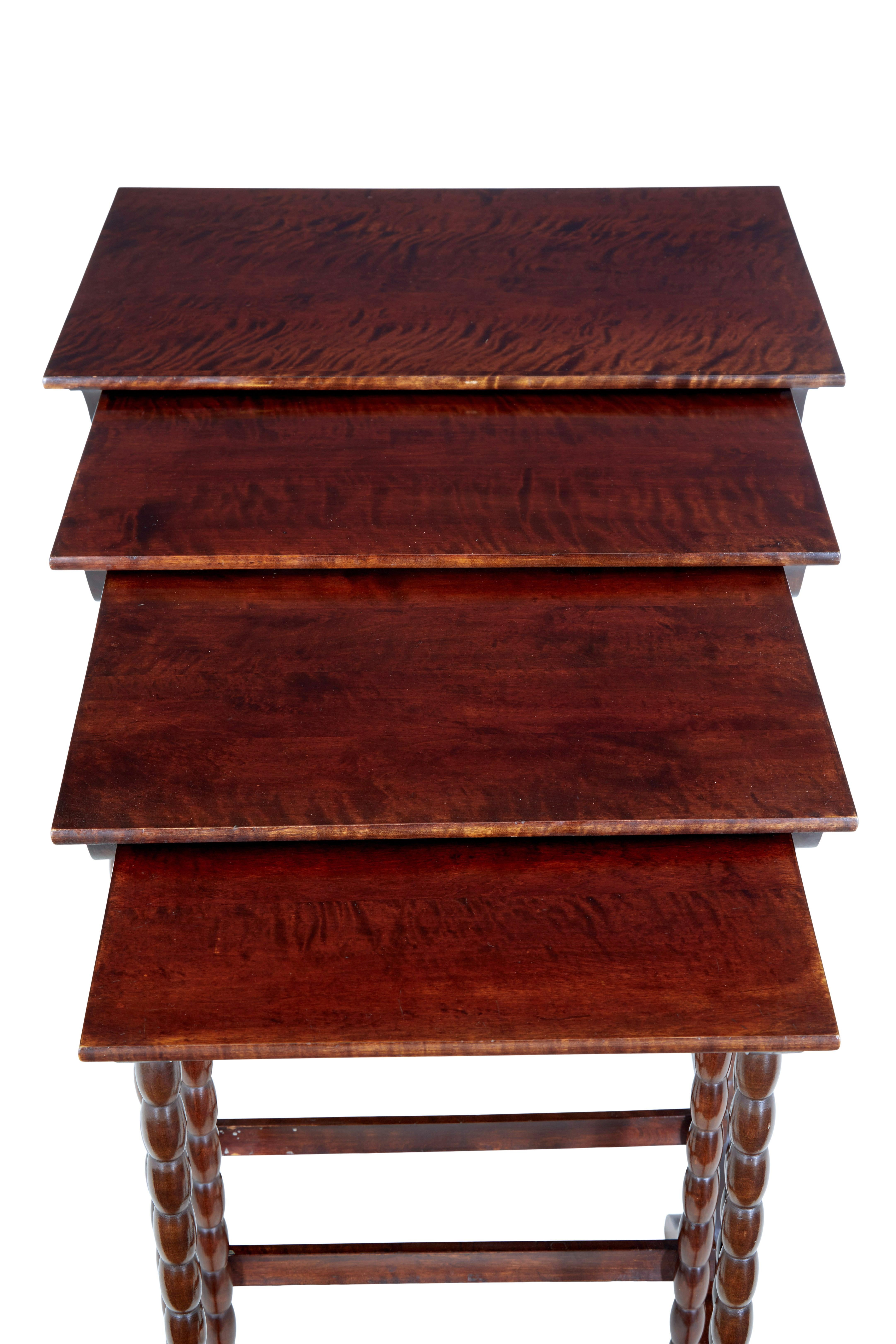 Set of 4 mid 20th century birch nest of tables circa 1950.

Good quality set of 4 tables that form a tight nest.  Dark stained birch to reflect the colour of mahogany.  Supported by bobbin turned legs, standing on sledge feet.

Minor surface marks