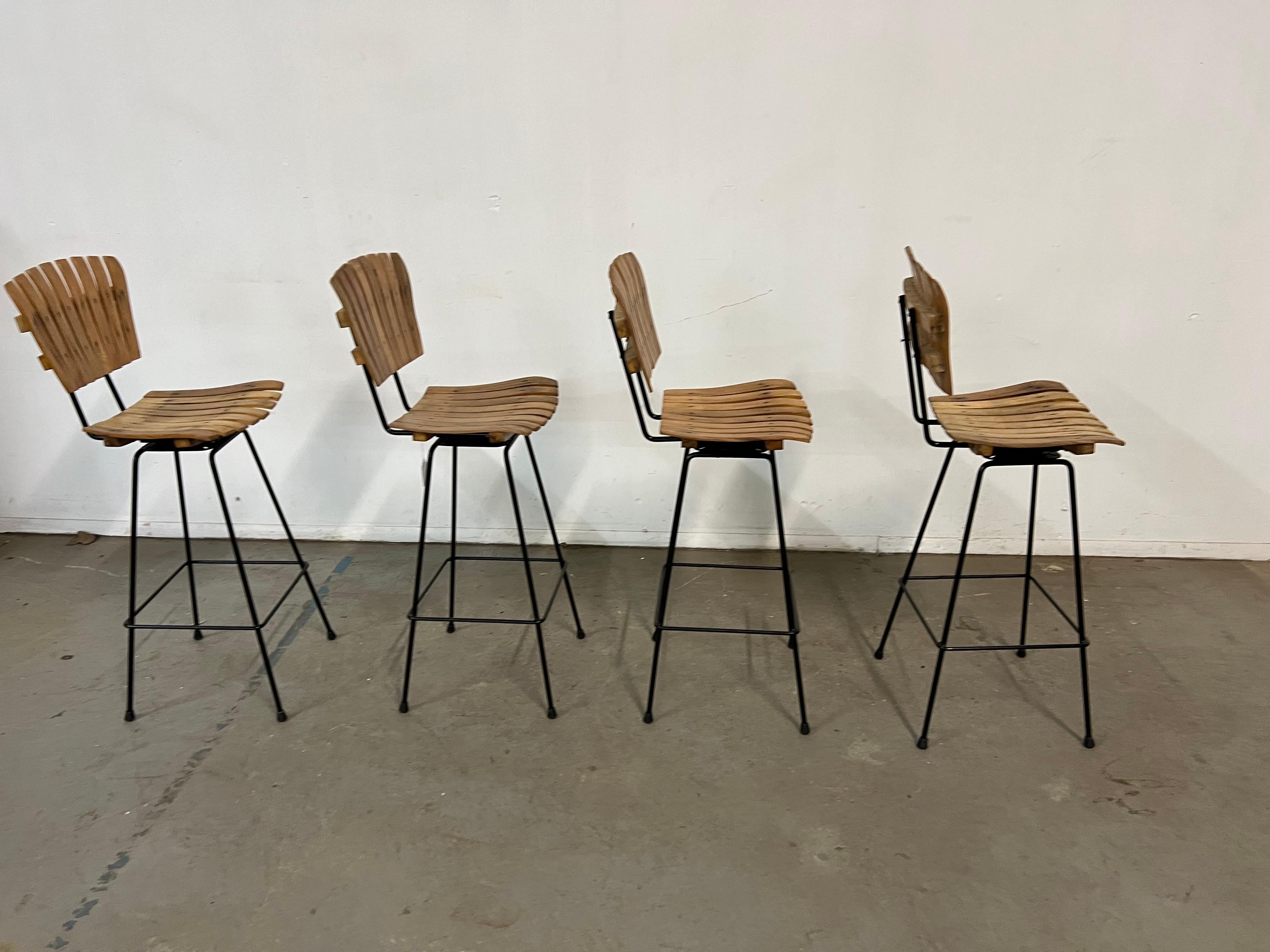 Set of 4 Mid-Century Arthur Umanoff Slat Style Bar Stools 

Offered is a great Set of 4 Mid-Century Arthur Umanoff Slat Style Bar Stools . They have the simple lines and design seen in this time period. These stools actually swivel. They are in good