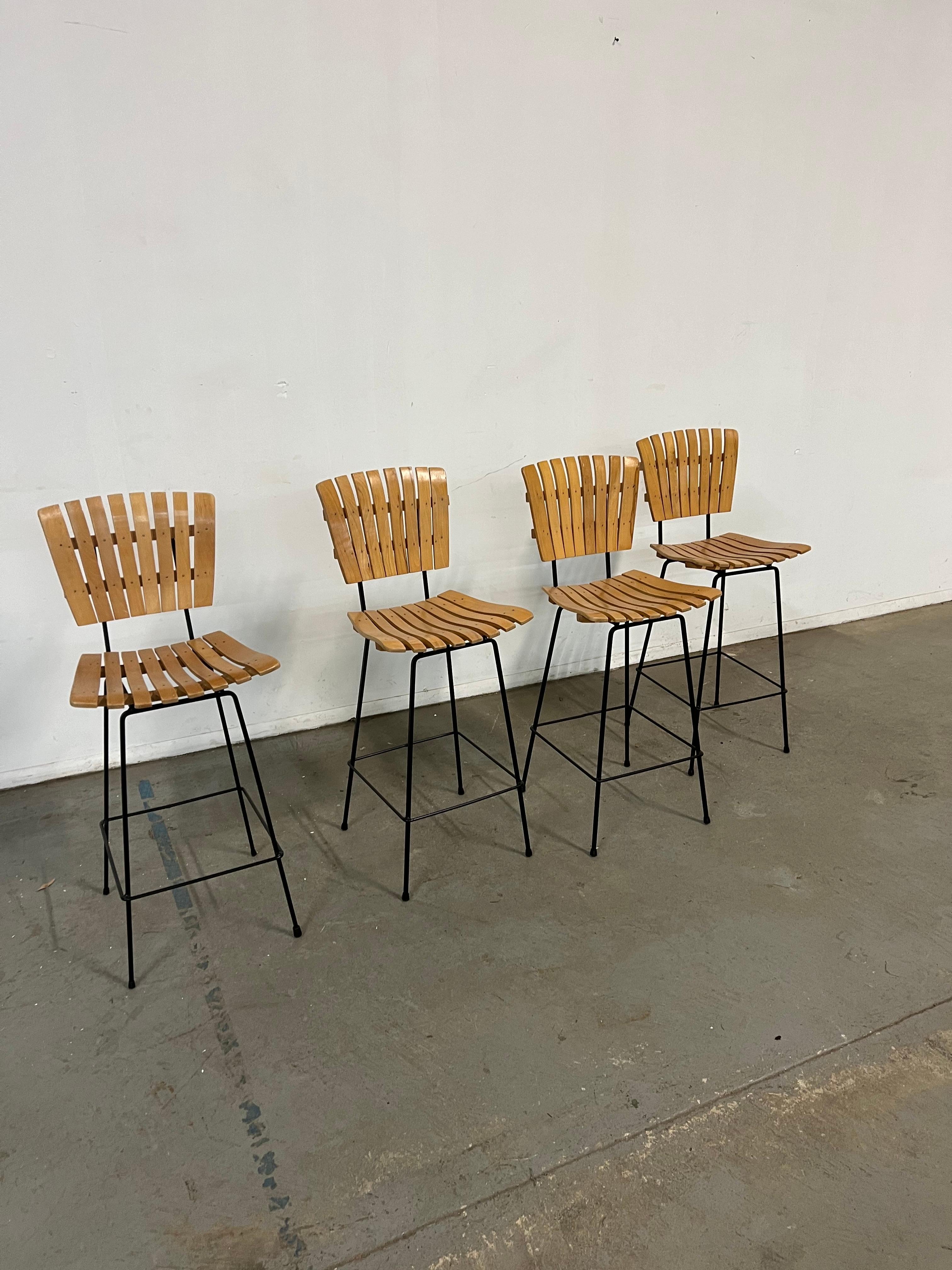Set of 4 Mid-Century Arthur Umanoff Slat Style Bar Stools 

Offered is a great Set of 4 Mid-Century Arthur Umanoff Slat Style Bar Stools . They have the simple lines and design seen in this time period. They are in good condition for their age