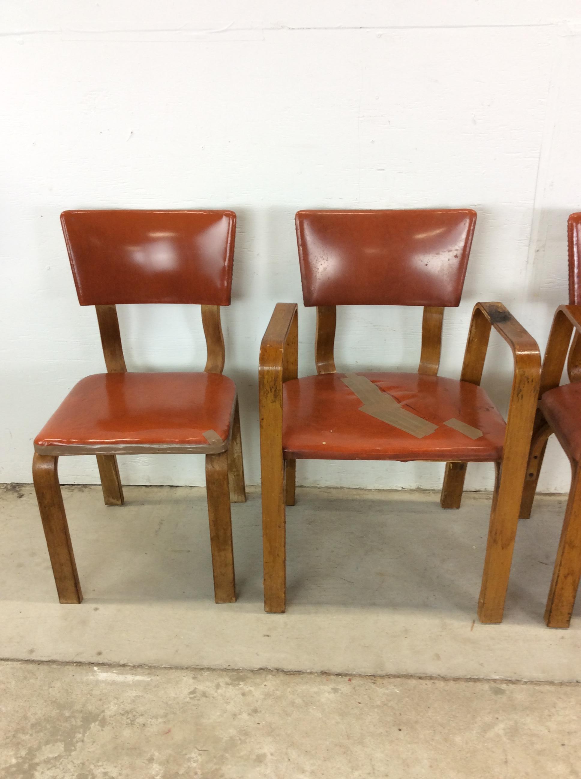 Il set di quattro sedie da pranzo moderne di metà secolo presenta una struttura in legno curvato, due poltrone e due sedie laterali con rivestimento in vinile vintage e alte gambe affusolate.u2028u2028Il tavolo da pranzo e il tavolino abbinato sono