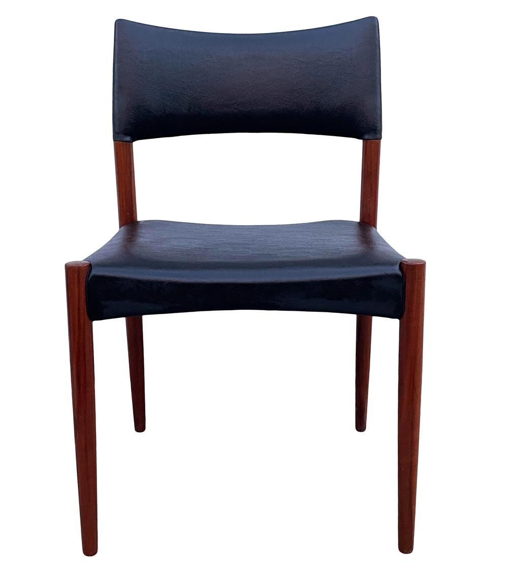 A simple modern set of dining chairs in teak designed by Villy Schou Andersen in the 1960's. The have solid teak frames with black naugahyde upholstery. Upholstery has some cuts and will need recovering. Price includes the set of four.