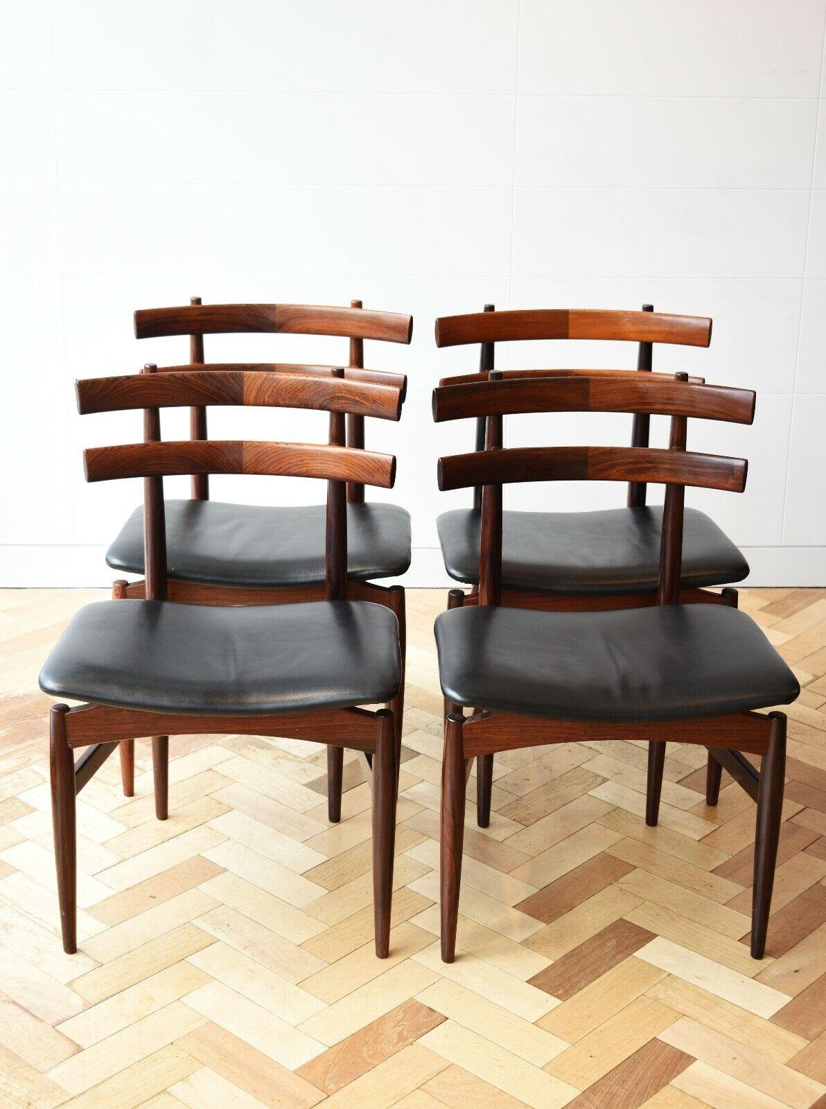An immensely stylish and rare set of 4 Danish rosewood dining chairs designed by Poul Hundevad, circa 1950's. 

These model number 30 chairs feature a curved two - rung ladder backrests with tapered legs in a beautiful deep Rosewood with black