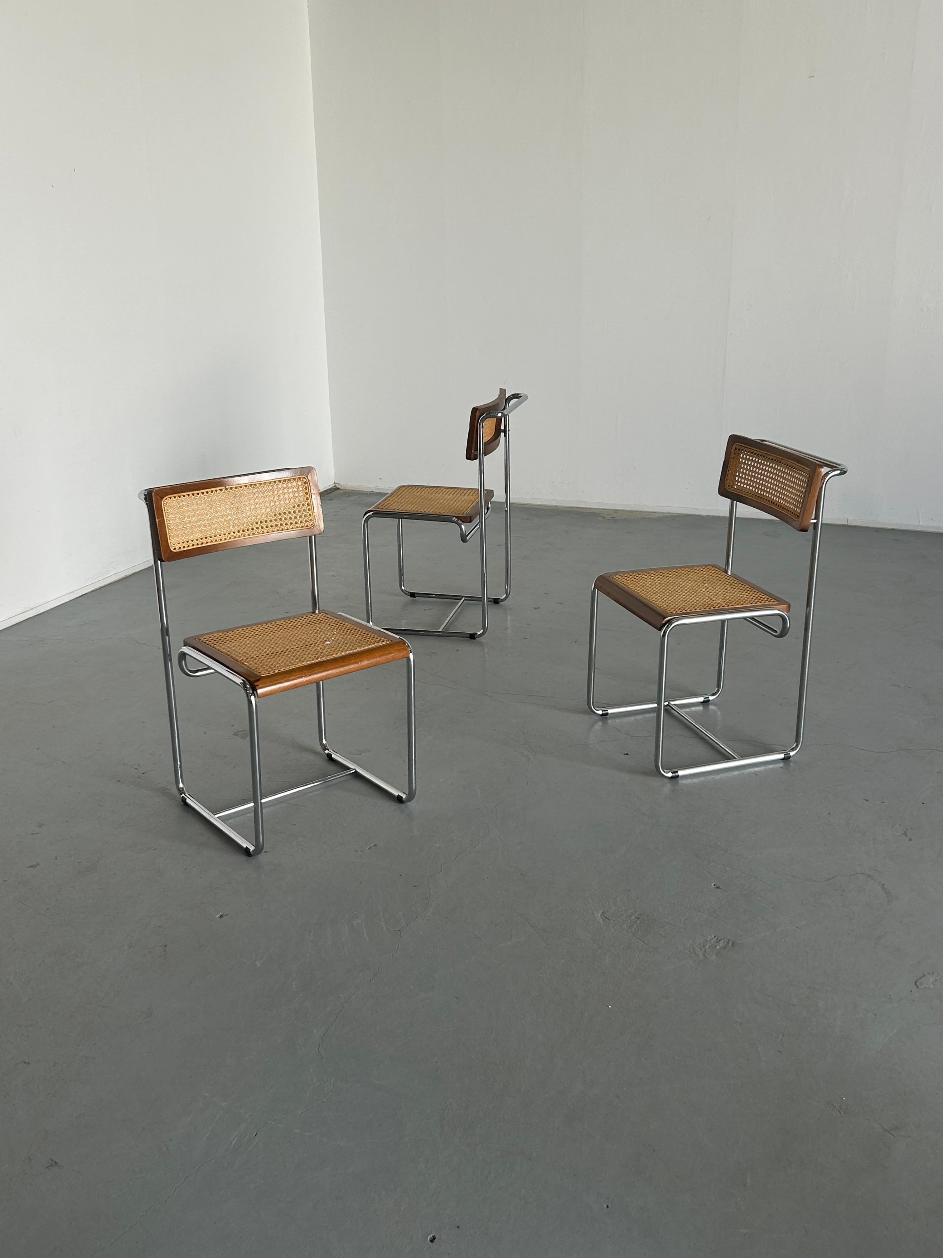 Unique and amazing Mid-Century-Modern constructivist dining chairs, in bent chromed tubular steel structure with wickered wooden seat and backrest. 
Elegant and simple design resembling a chair prototype of the school of Bauhaus. 
Early 1960s
