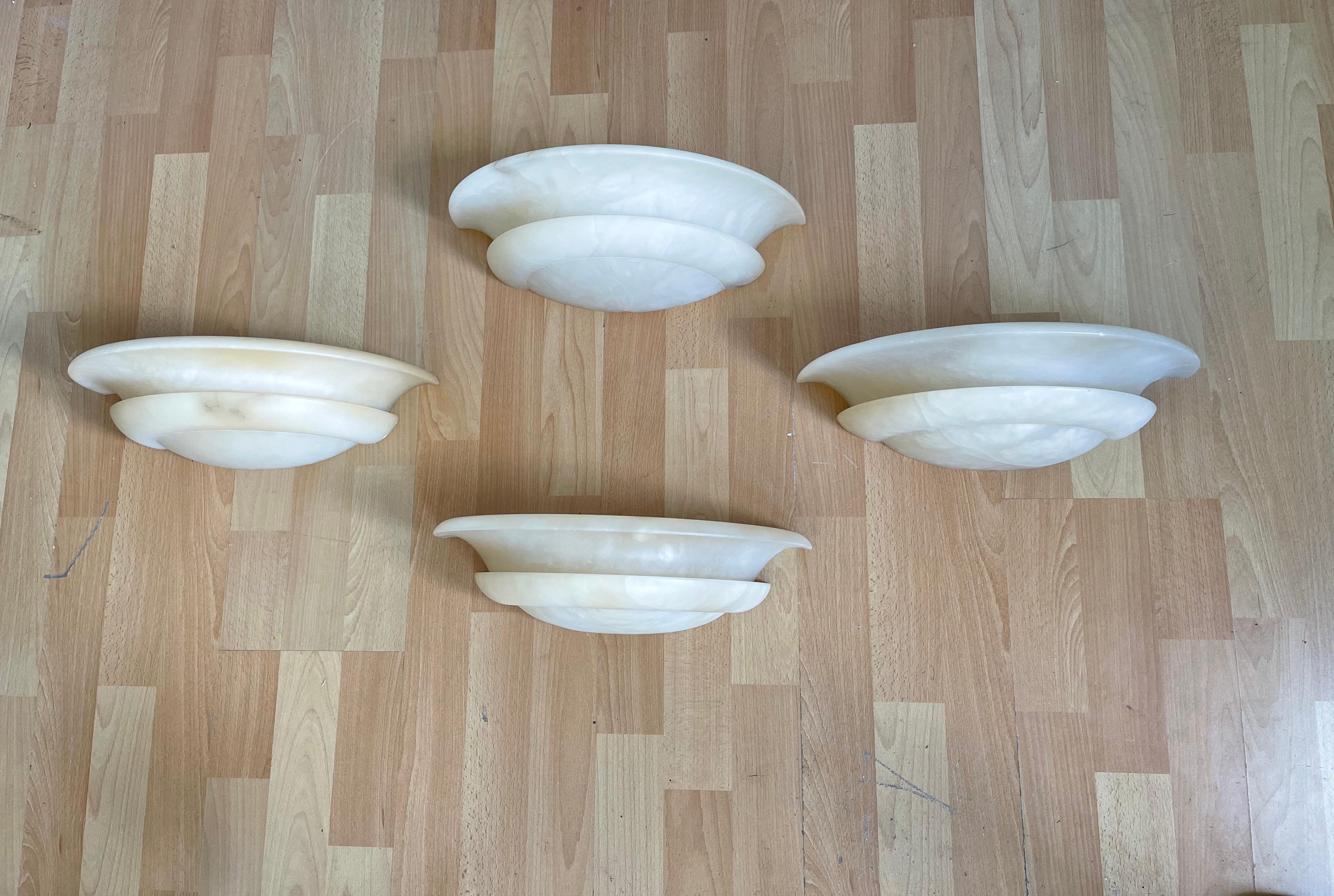 Wonderful shape, perfect size and excellent condition alabaster sconces.

This excellent condition set of four of alabaster light fixtures for wall mounting will look great no matter where you decide to use them. These shades are all handmade out of