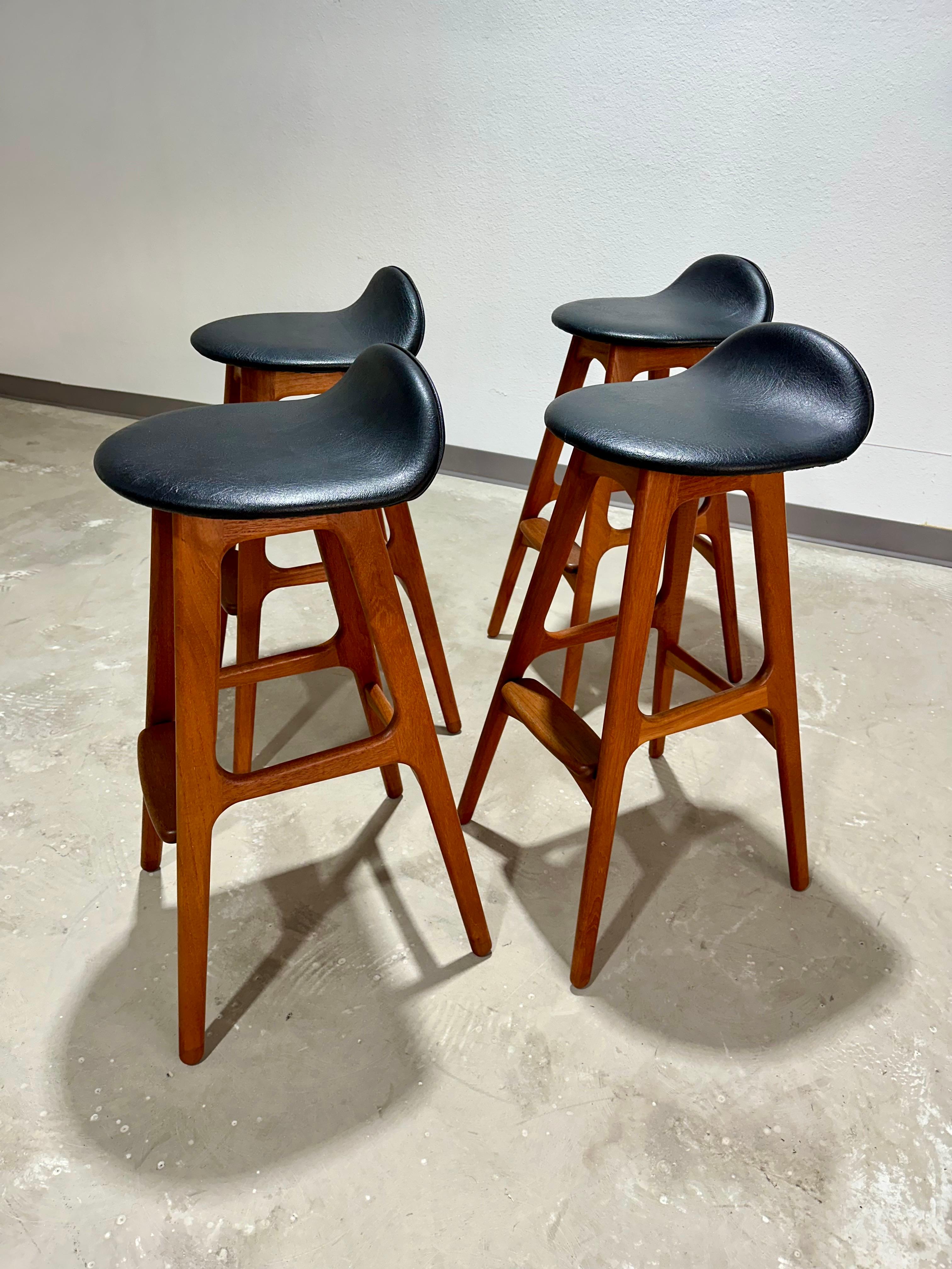 Set of 4 Mid Century Danish Teak and Black Leatherette model 61 bar stools attributed to Erik Buch for Oddense. Original foil stickers *not present*, we’ll document design. Great original vintage condition, outfitted in the original black