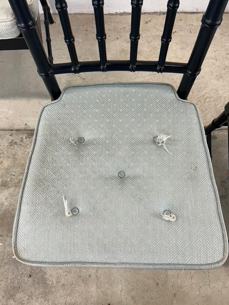 This set of four dining chairs feature hardwood frames with original black paint, caned wicker seats and removable tufted cushions.

Dimensions: 22.5w 21d 34.75h 19sh 26ah

Condition notes: Black paint on these chairs shows considerable wear on the