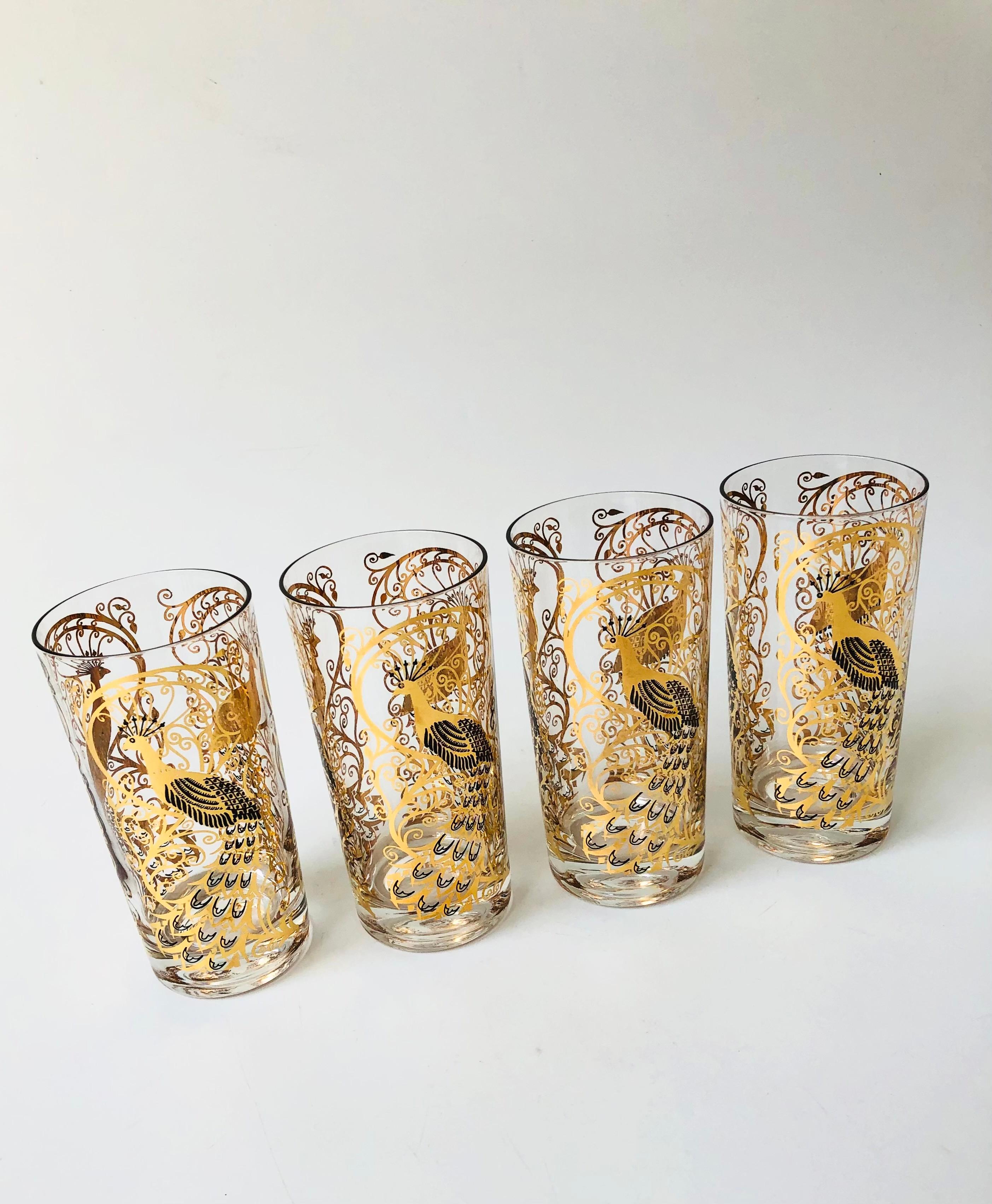 A gorgeous set of 4 mid century highball cocktail glasses. Each piece is decorated in an ornate peacock pattern in black and metallic gold. Made by Osborne Kemper Thomas.

