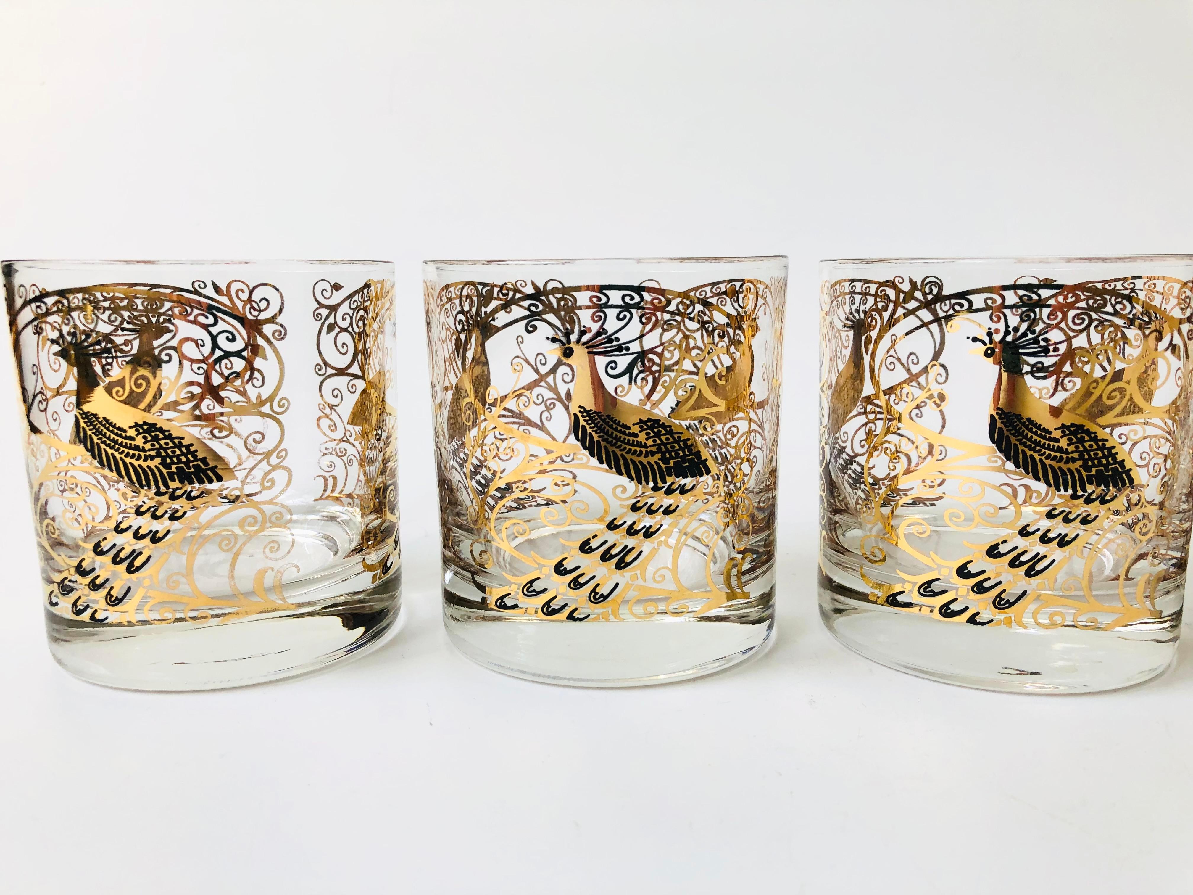 A gorgeous set of 4 mid century lowball cocktail glasses. Each piece is decorated in an ornate peacock pattern in black and metallic gold. Made by Osborne Kemper Thomas.

