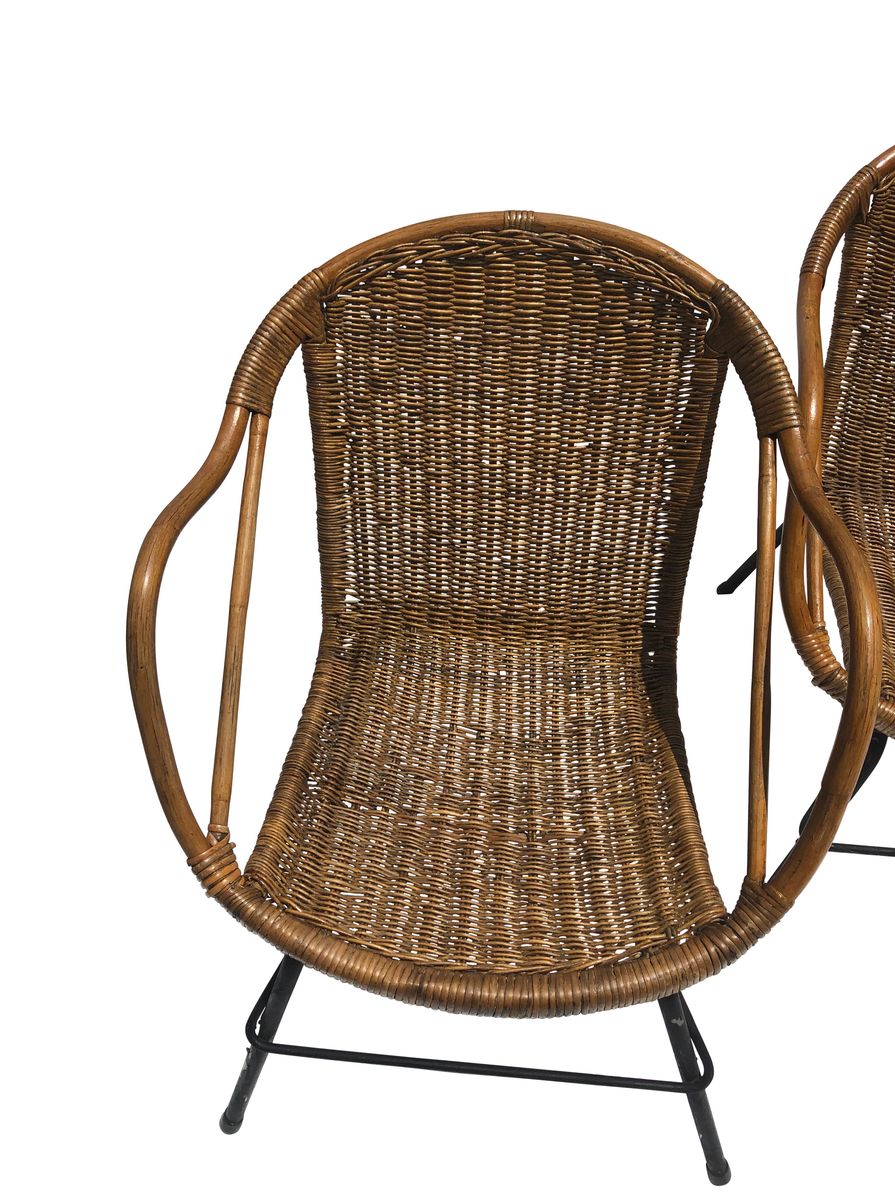 Set of 4 Vintage Italian wicker bucket chairs with black iron legs. Some wicker losses. Seat height is 14” and interior width is 17.5”. Finish has been refreshed.
 
