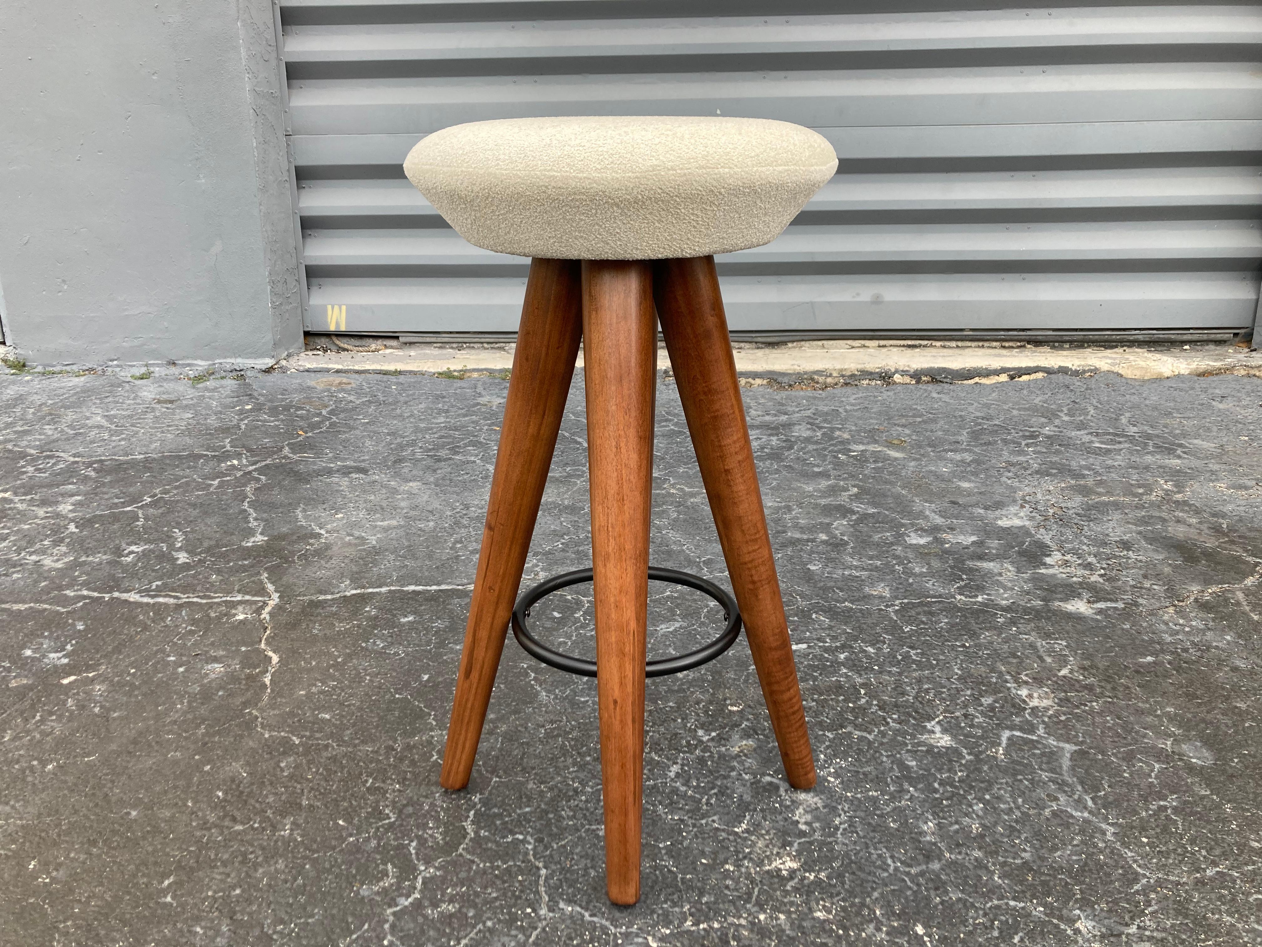 Set of 4 Mid-Century Modern bar stools, seats were recovered in beautiful ivory fabric. Legs have a walnut finish. Ready for a new home.