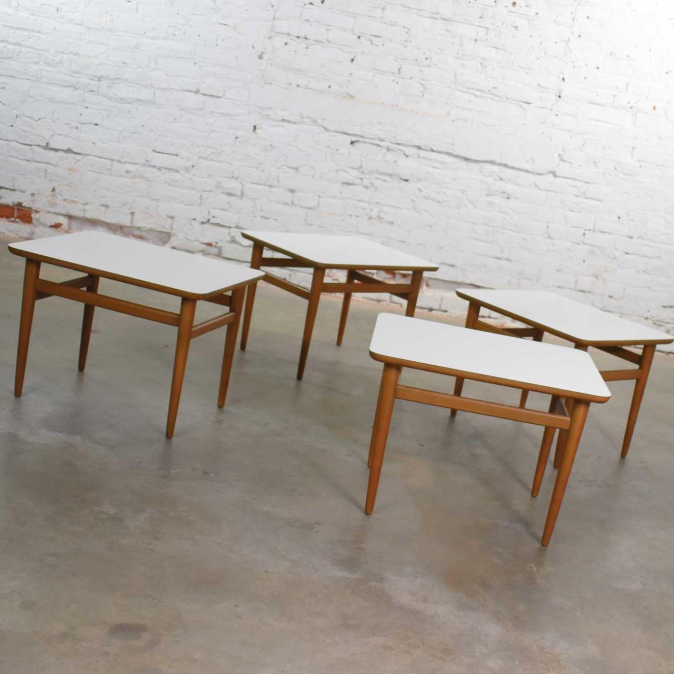 Very handsome and versatile set of 4 Mid-Century Modern rectangular birch side tables with white laminate tops and tapered legs. They are in wonderful vintage condition. The birch frames have undergone some restoration and are now fabulous but not