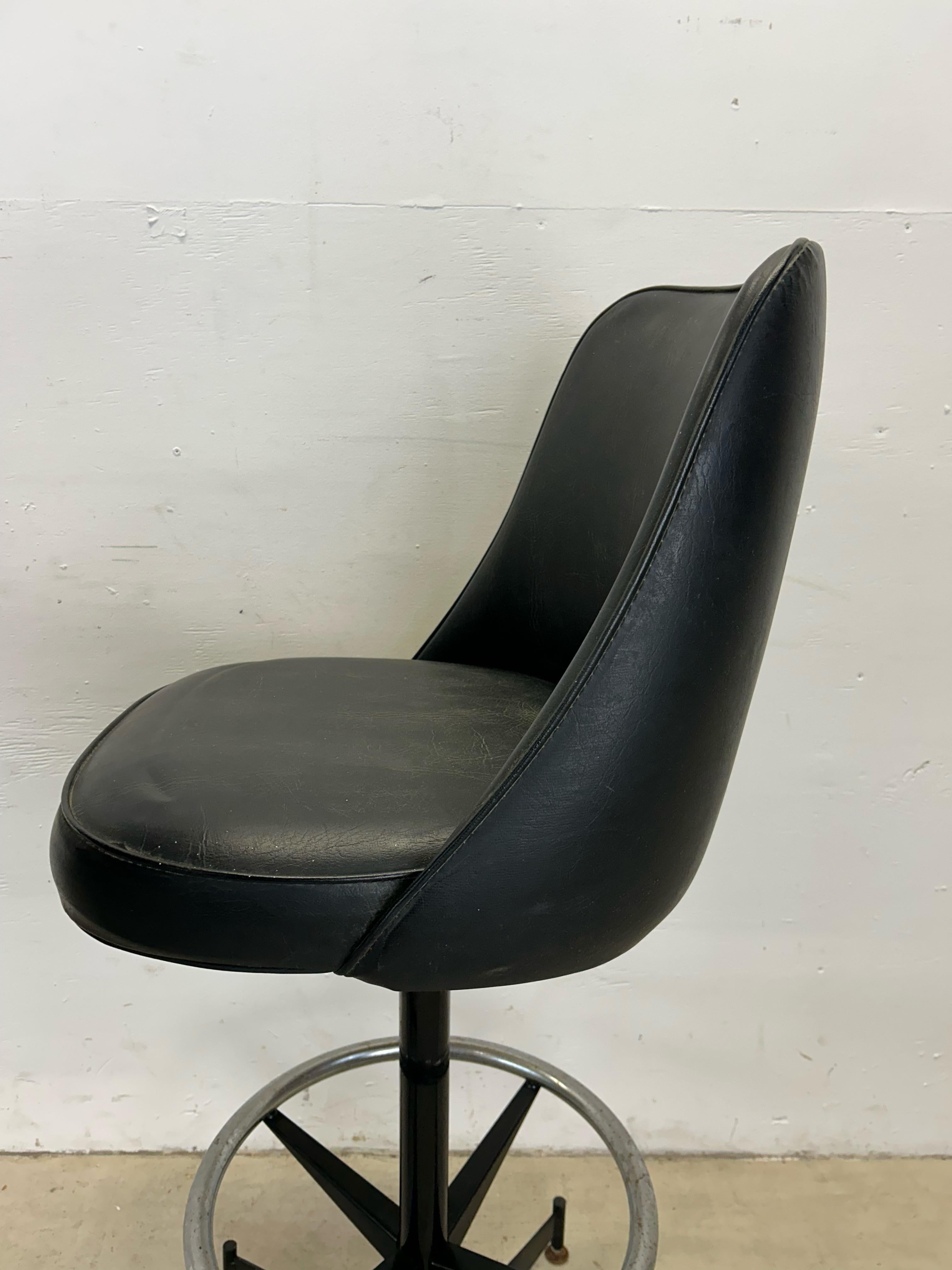 This set of four mid century modern bar stools feature original black vinyl upholstery, swivel seat atop a black painted base, chrome accented kick rail, and chrome feet.

Dimensions: 19w 20d 44h 31sh

Condition: Original black vinyl is seriously