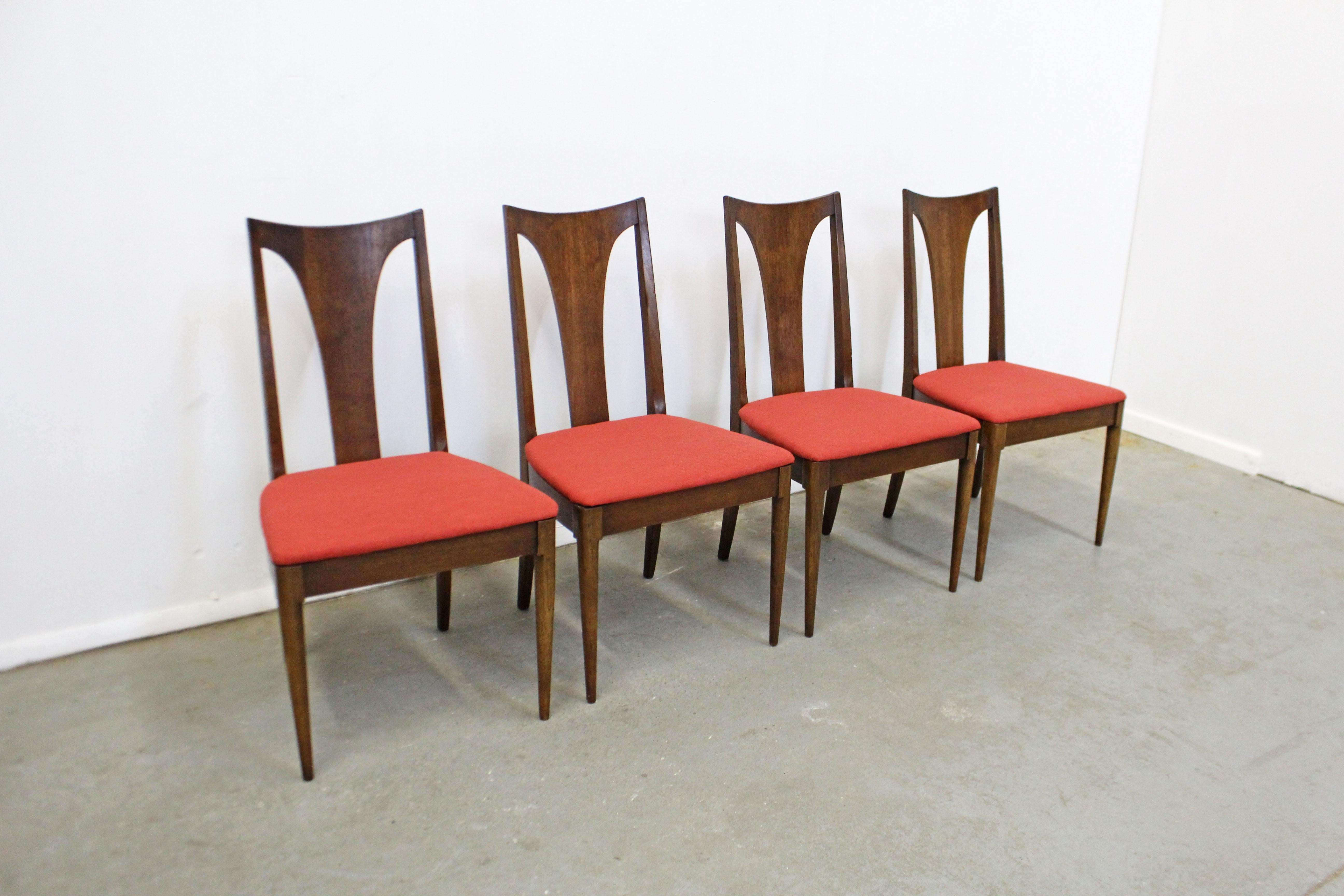 What a find. Offered is a vintage Mid-Century Modern chair set by Broyhill 'Brasilia'. They are made of walnut with red upholstered seats. They are in good, structurally sound condition with reupholstered seats, shows some surface wear, scratches,
