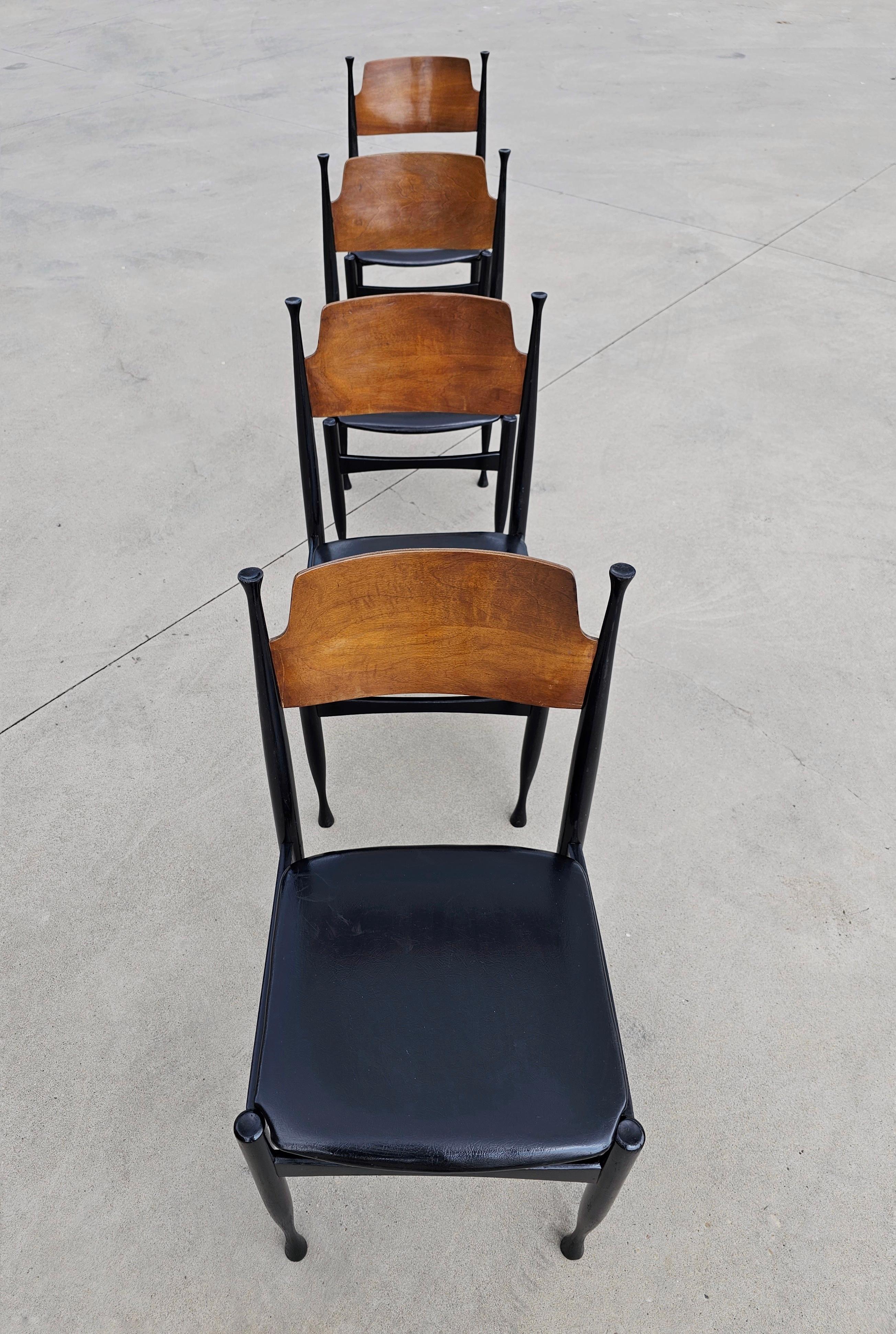 In this listing you will find a gorgeous and very rare set of 4 Mid-Century Modern dining chairs in style of Paolo Buffa. They feature construction in solid wood, painted black, the backrest is left in natural wood colour, while the seats are