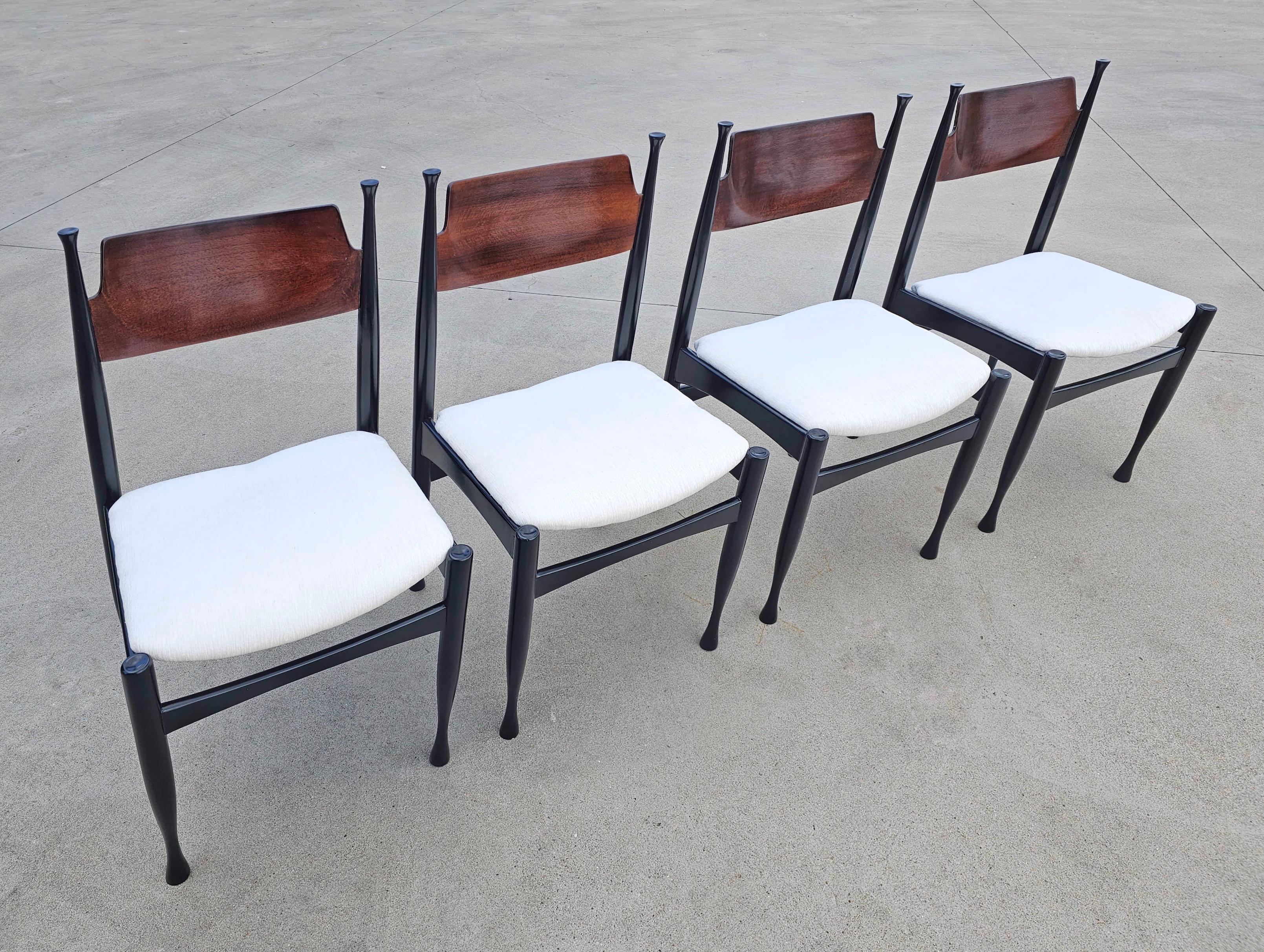 In this listing you will find a gorgeous and very rare set of 4 Mid-Century Modern dining chairs in the style of Paolo Buffa. They feature construction in solid beech wood, painted black, the backrest is done in mahogany plywood, while the seats are