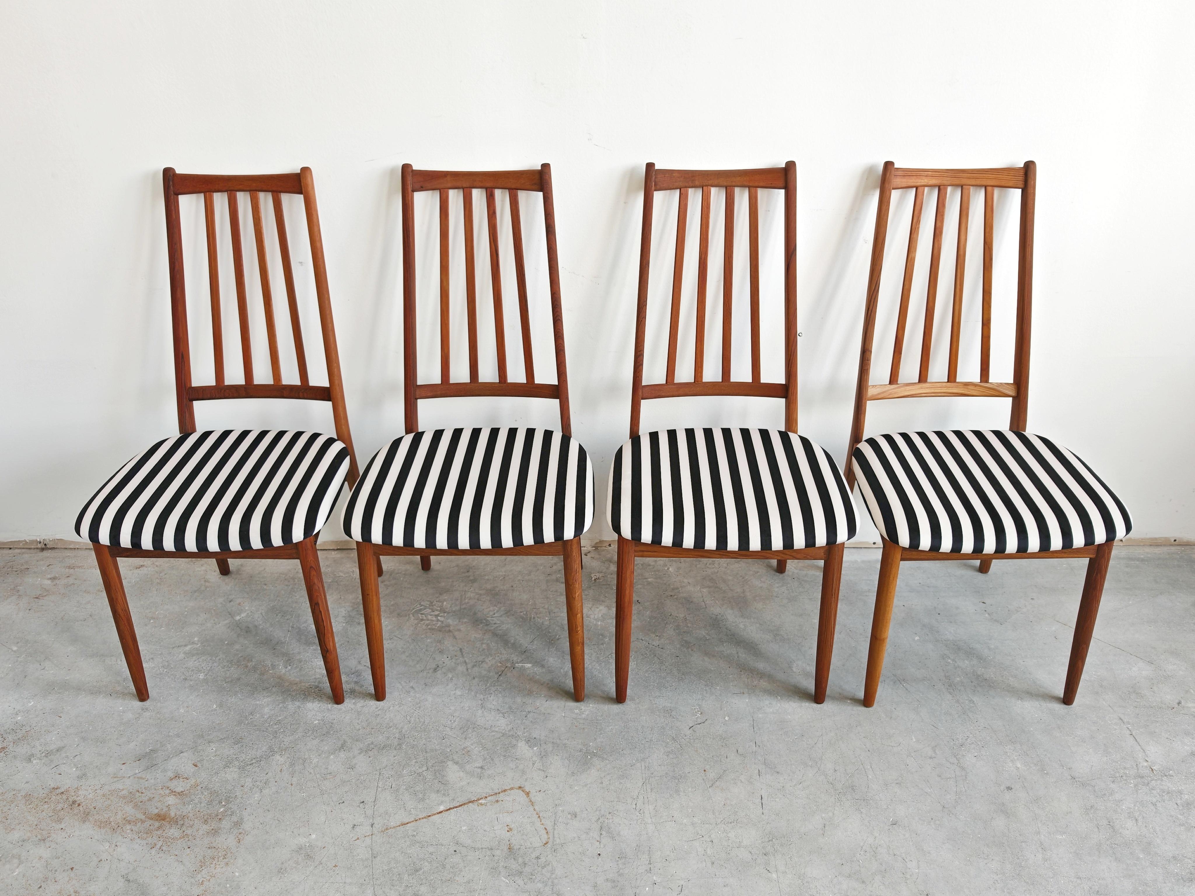 In this listing you will find a set of 4 stunning Mid Century Modern Dining Chairs with high backs, made in solid teak. They feature elegant, sleek design, enhanced with a black and white stripes plush. Chairs are done in style of Arne Vodder.