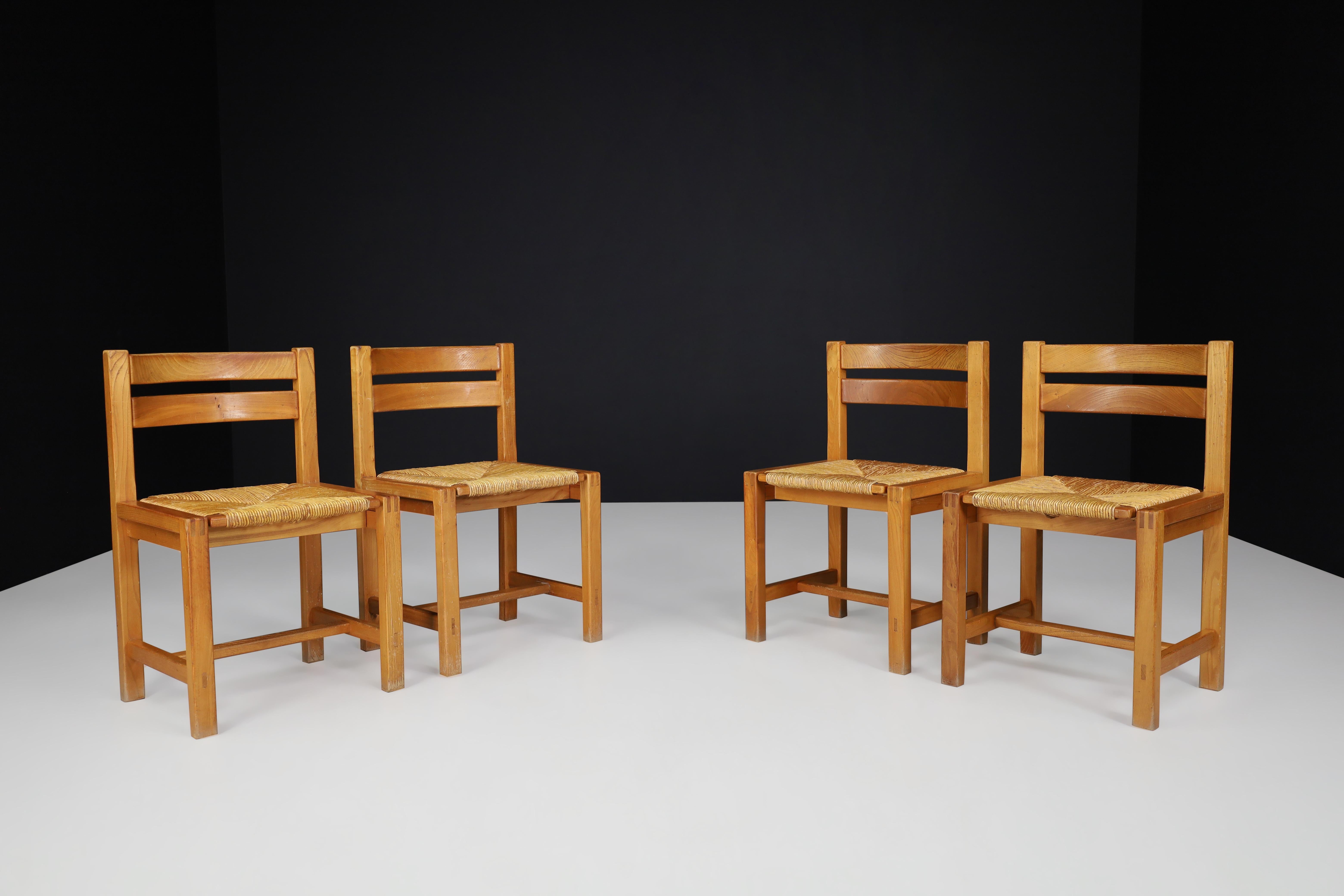 Set of Four Mid-Century Modern Elm and Rush Dining Chairs by Maison Regain, France, 1960s

A striking set of four dining chairs manufactured by the esteemed French atelier Maison Regain in the 1970s. Known for its dedication to refined craftsmanship