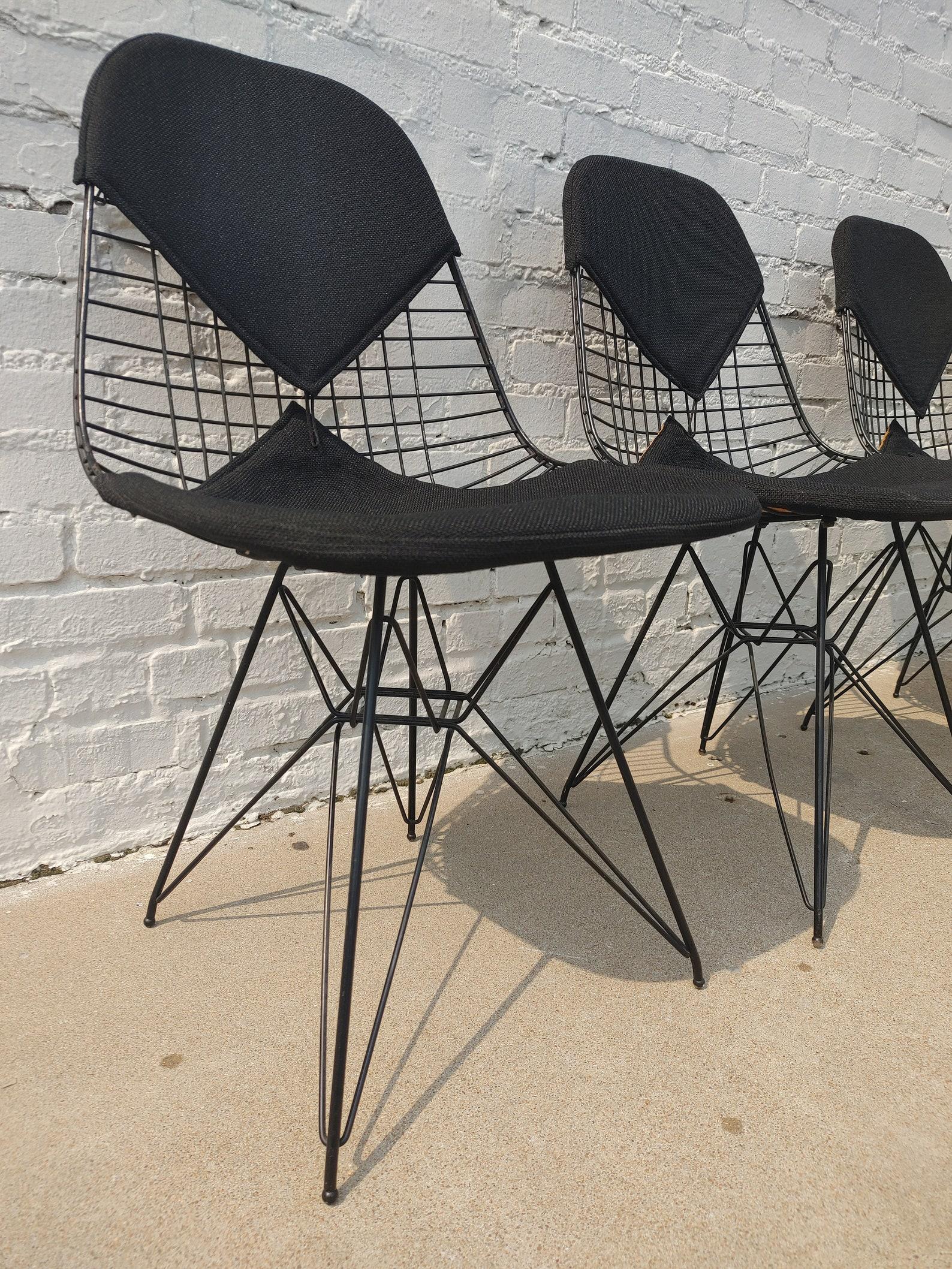Set of 4 Mid Century Modern Herman Miller Eiffel Wire Chairs
 
Above average vintage condition and structurally sound. Have some expected slight finish wear and scratching. Bikini buttons which hold the top upholstery to the bottom are all missing.