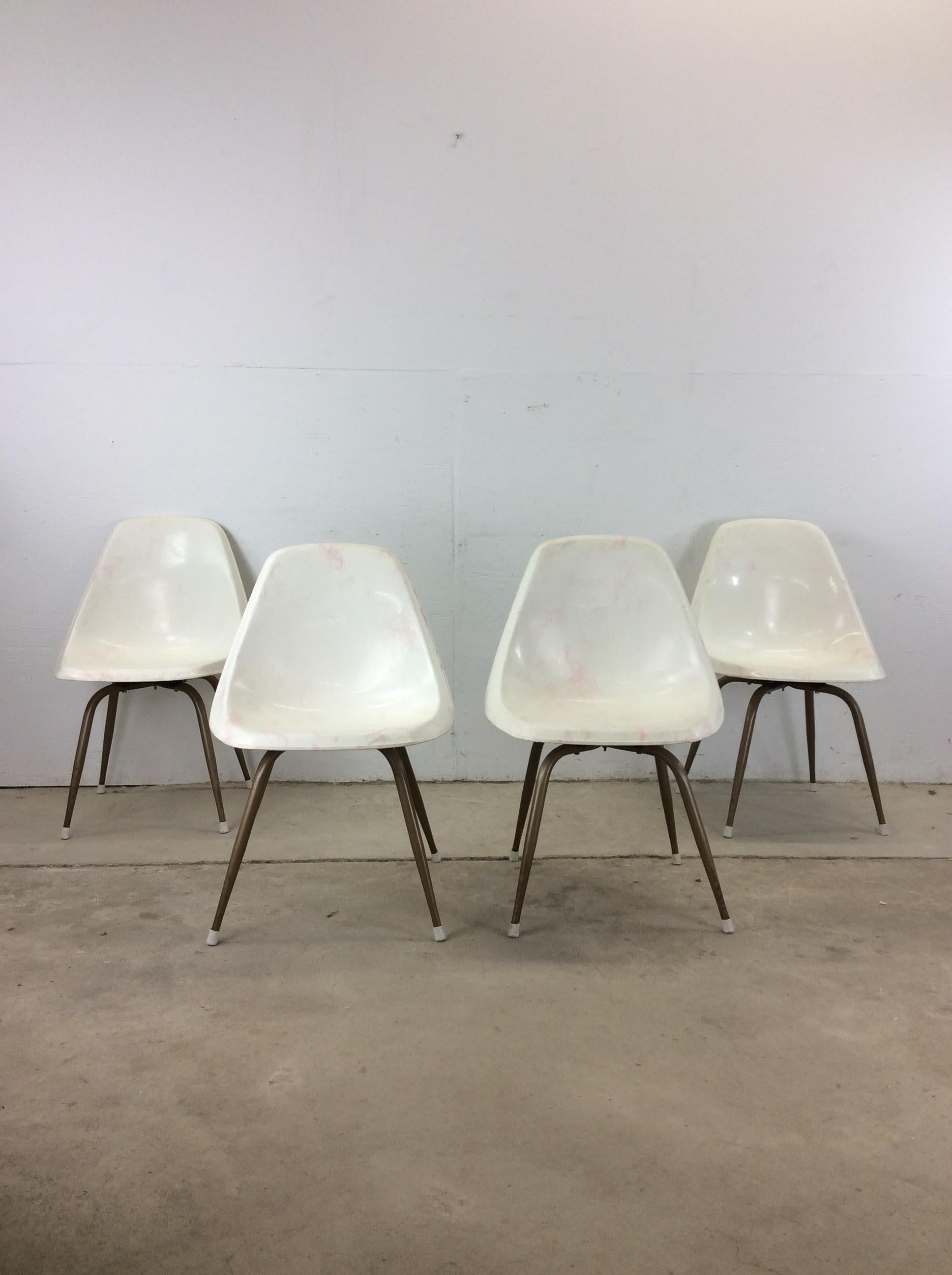 This set of 4 mid century modern chairs feature molded plastic construction, unique white and pink design, and swivel base with four copper colored legs.

Dimensions: 21w 21.5d 31.5h 17.5sh 

Condition notes: Molded plastic seats have some