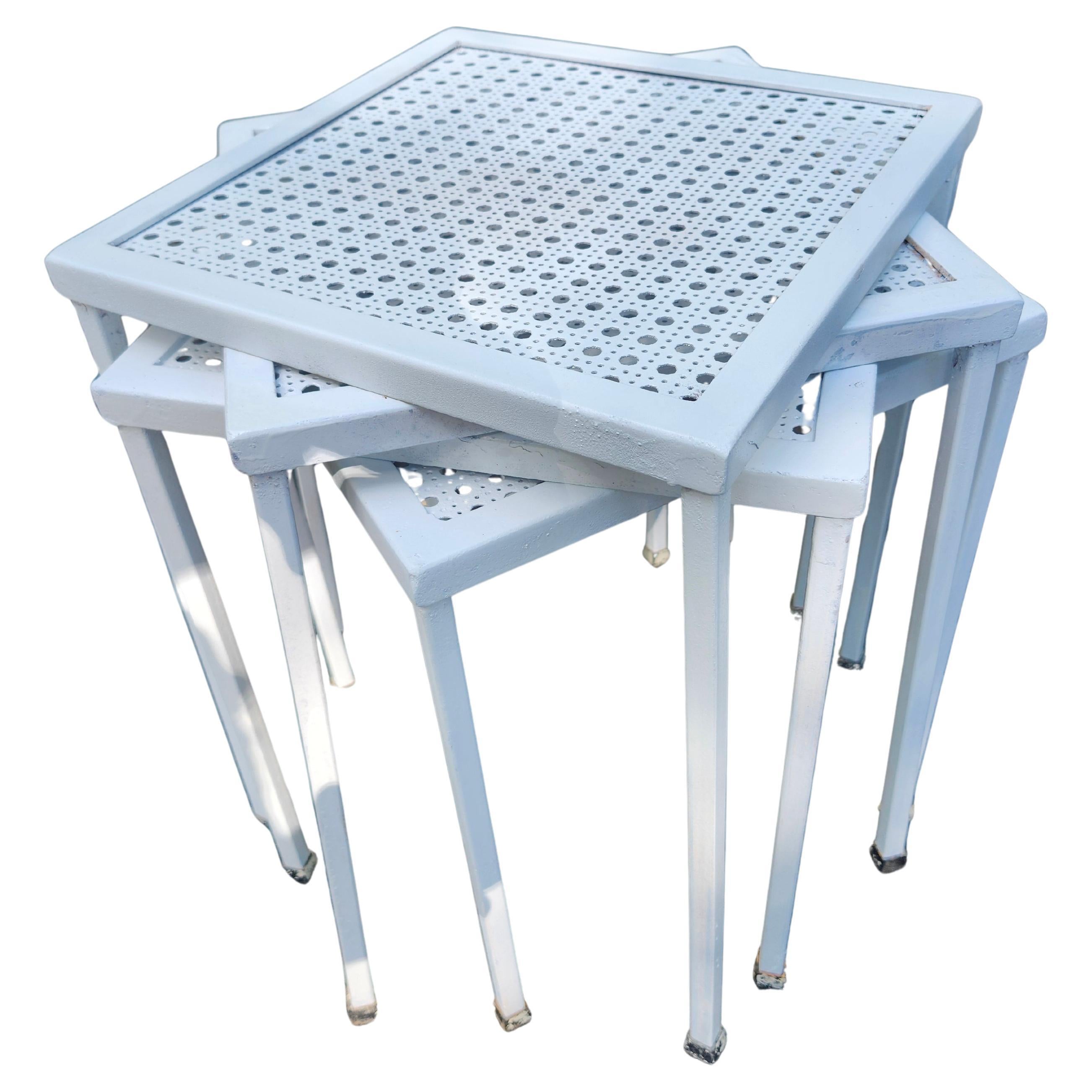 Fabulous set of 4 matching Stacking tables with iron legs and a Pierced Metal top. Recently sanded and resprayed. Original rubber feet tips on all legs. In excellent vintage condition with minimal wear. Priced and sold as a set of 4.