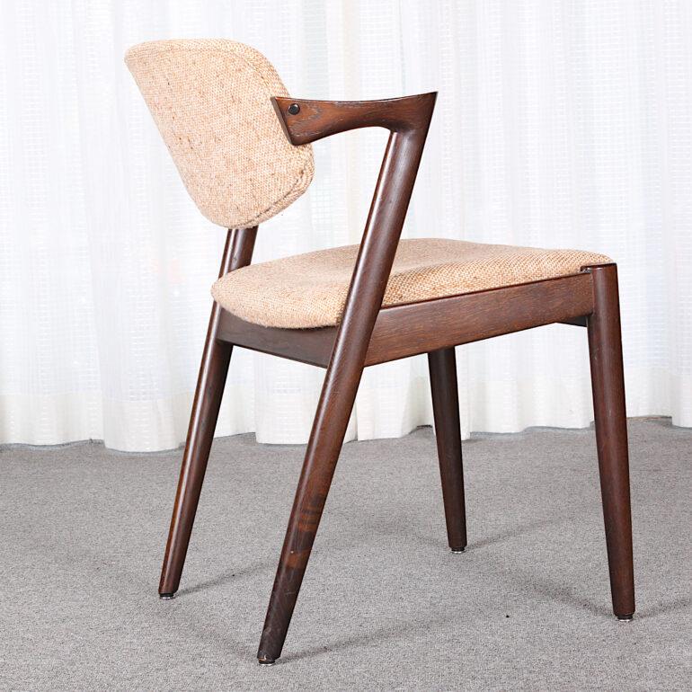 Z dining chairs, model 42, designed by Kai Kristiansen and manufactured in Denmark by Schou Andersen Møbelfabrik. The chairs are made from solid hardwood, featuring tapered legs, curved armrests. This set is it's original condition needing