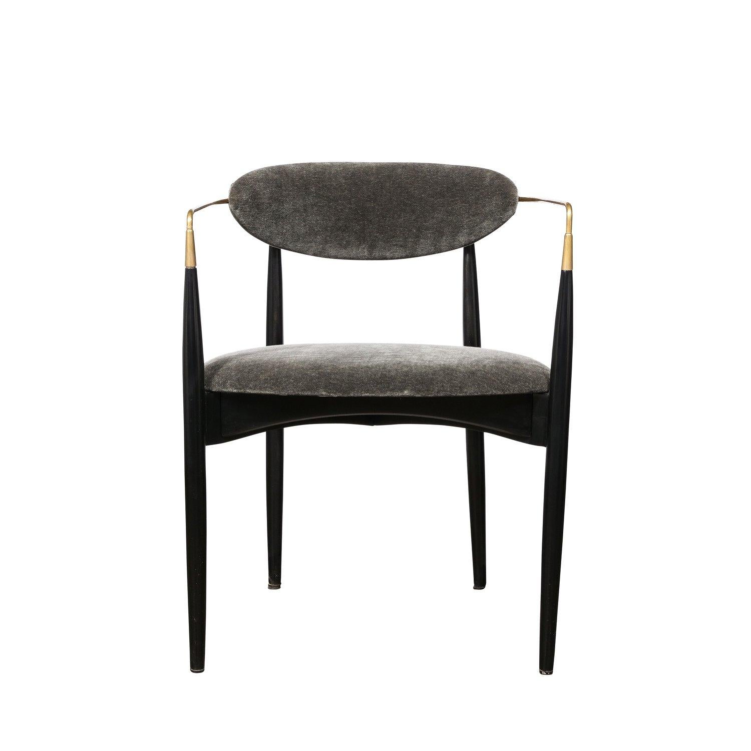 This Set of Four Mid-Century Modernist Sculptural Chairs in Black Enameled Walnut with Brass Arms are created by Kofod-Larsen and originate from Denmark, Circa 1960. Featuring a gorgeous open framework to the construction with an upholstered seat