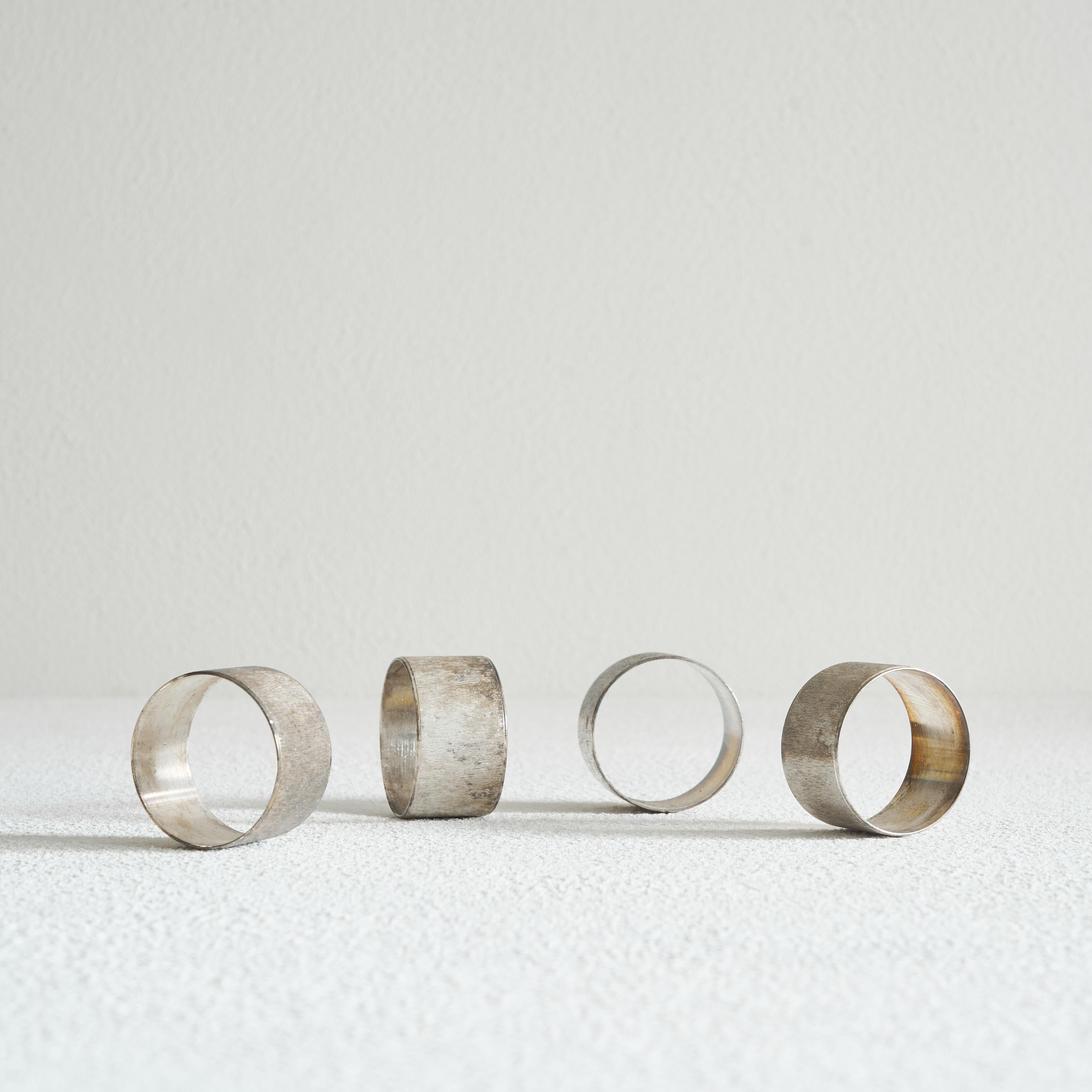Set of 4 midcentury Napkin Rings in Patinated Silver.

Beautiful midcentury set of 4 napkin rings in highly patinated silver. Wonderful texture and rich patination, which give these napkin rings a very interesting appearance. If you like your