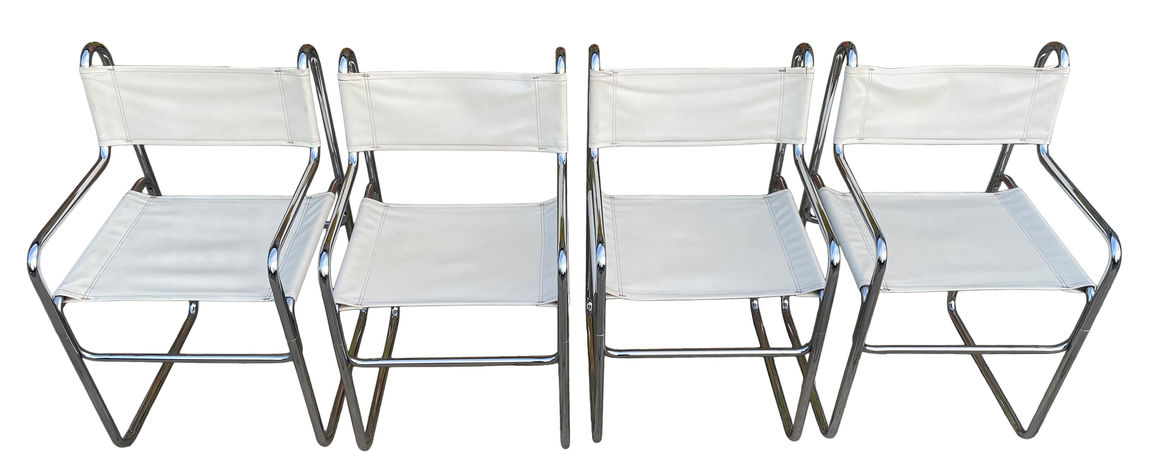 Set of 4 mid century tubular chrome faux white leather sling dining chairs. Matching set all in good condition very clean set. Great for use as dining chairs or side chairs. Style of Cassina.

Located in Brooklyn NYC

Measures: 17