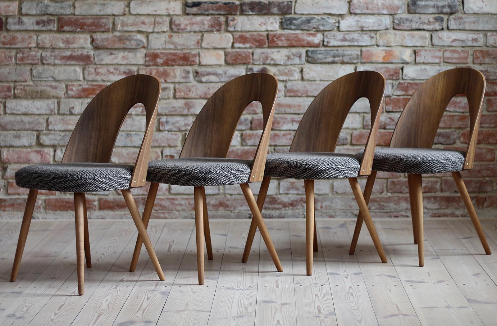 This set of four vintage dining chairs was designed by Czech designer Antonin Šuman in the 1960s. The chairs have been completely restored finished with high-quality oil that gave them beautiful and natural finish. The set is reupholstered with