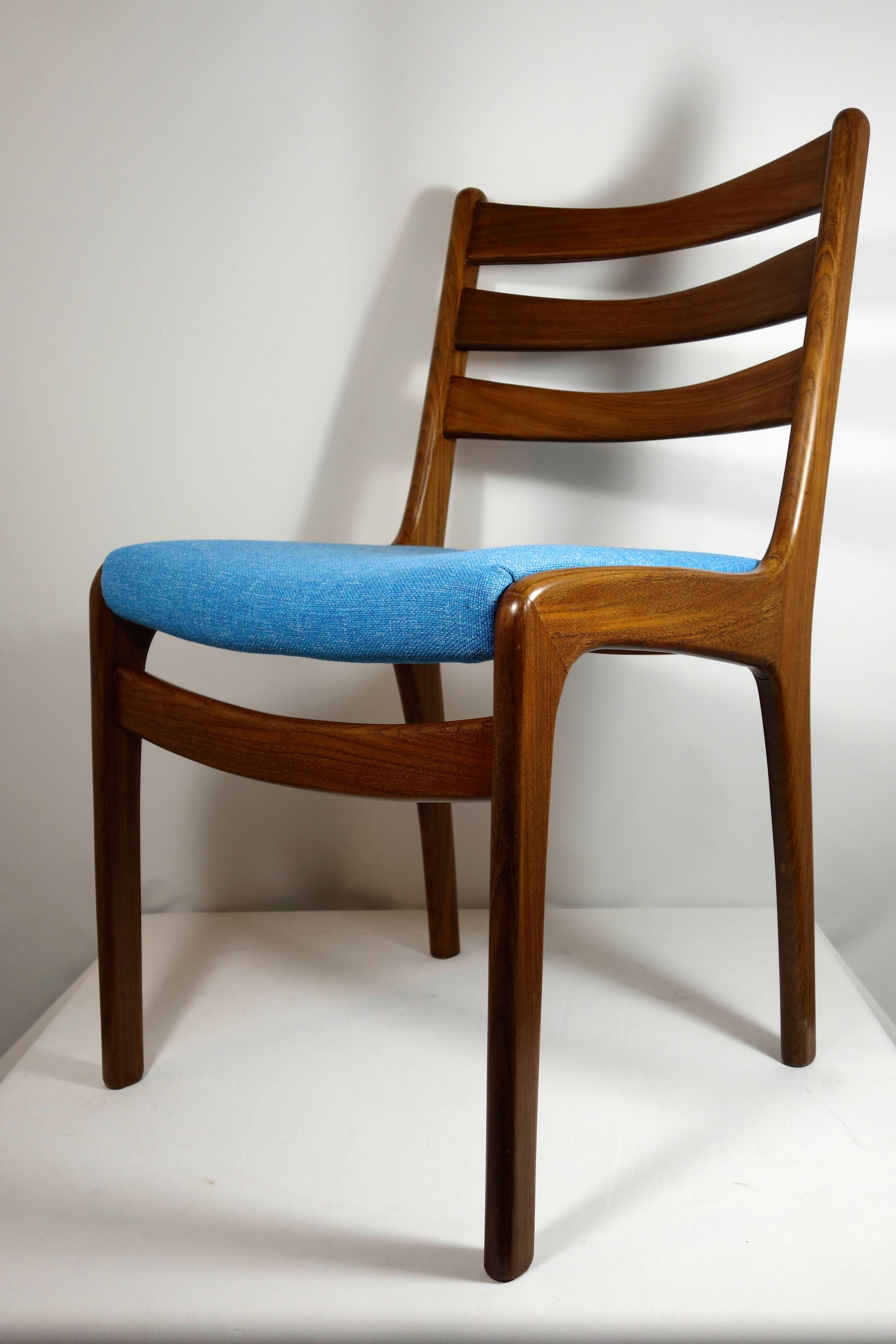 These elegant midcentury dining chairs from Scandinavia are made of teak wood, They have been reupholstered with a refined but strong blue fabric.