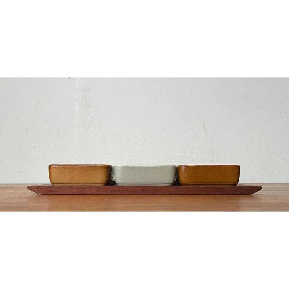 Mid-Century West German Pottery WGP Stacking Bowls with Teak Tray, 1960s, Set of 4, in Very Good conditions. Designed 1960 to 1969.

Additional information:
Material: Ceramic, Teak
Color: Blue
Styles: Mid-Century Modern
Country of Origin: