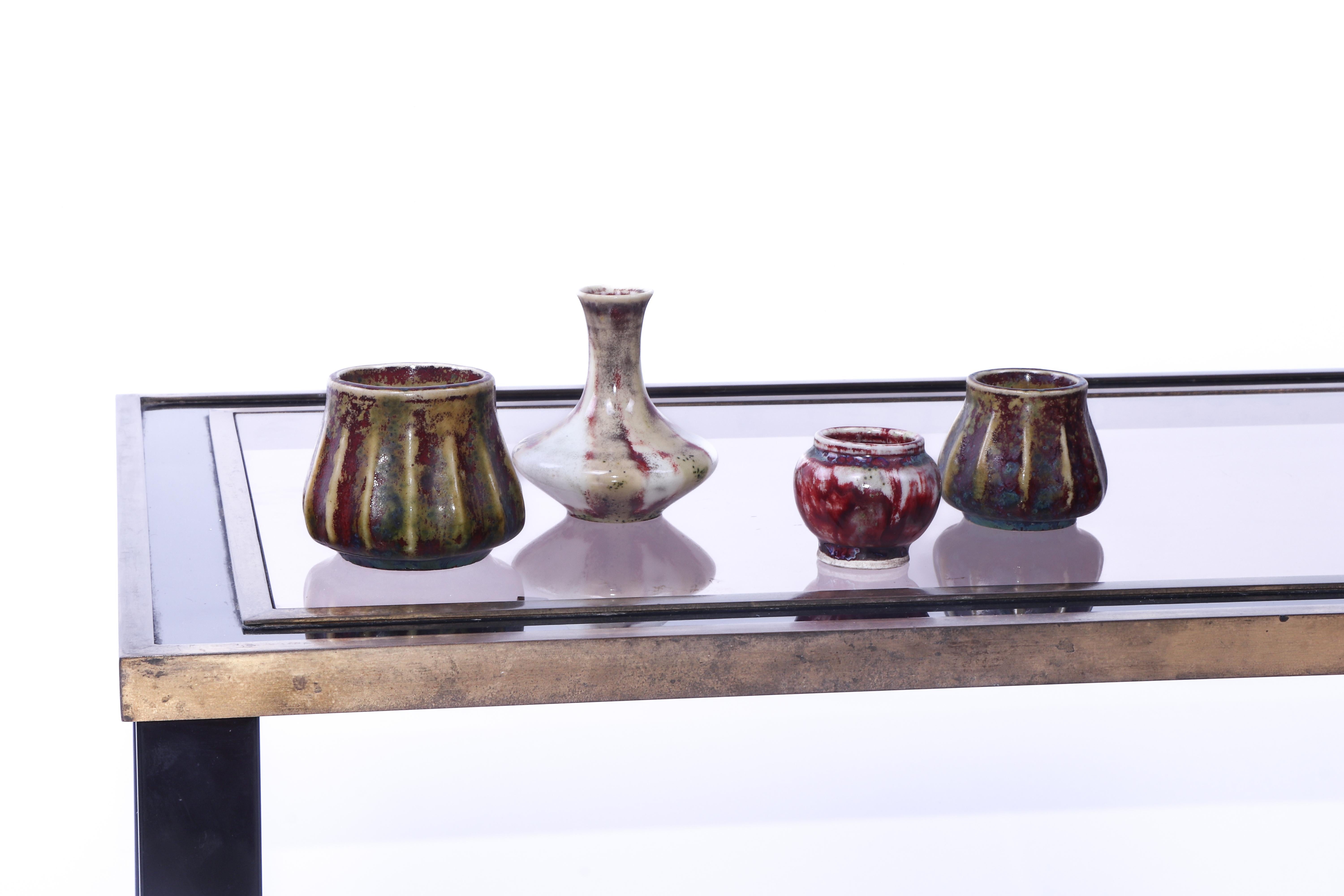 Set of 4 miniature 'Oxblood' glaze ceramic vases by Pierre-Adrien Dalpayrat, circa 1895. The tallest vase stands at 8.8 cm high. 
