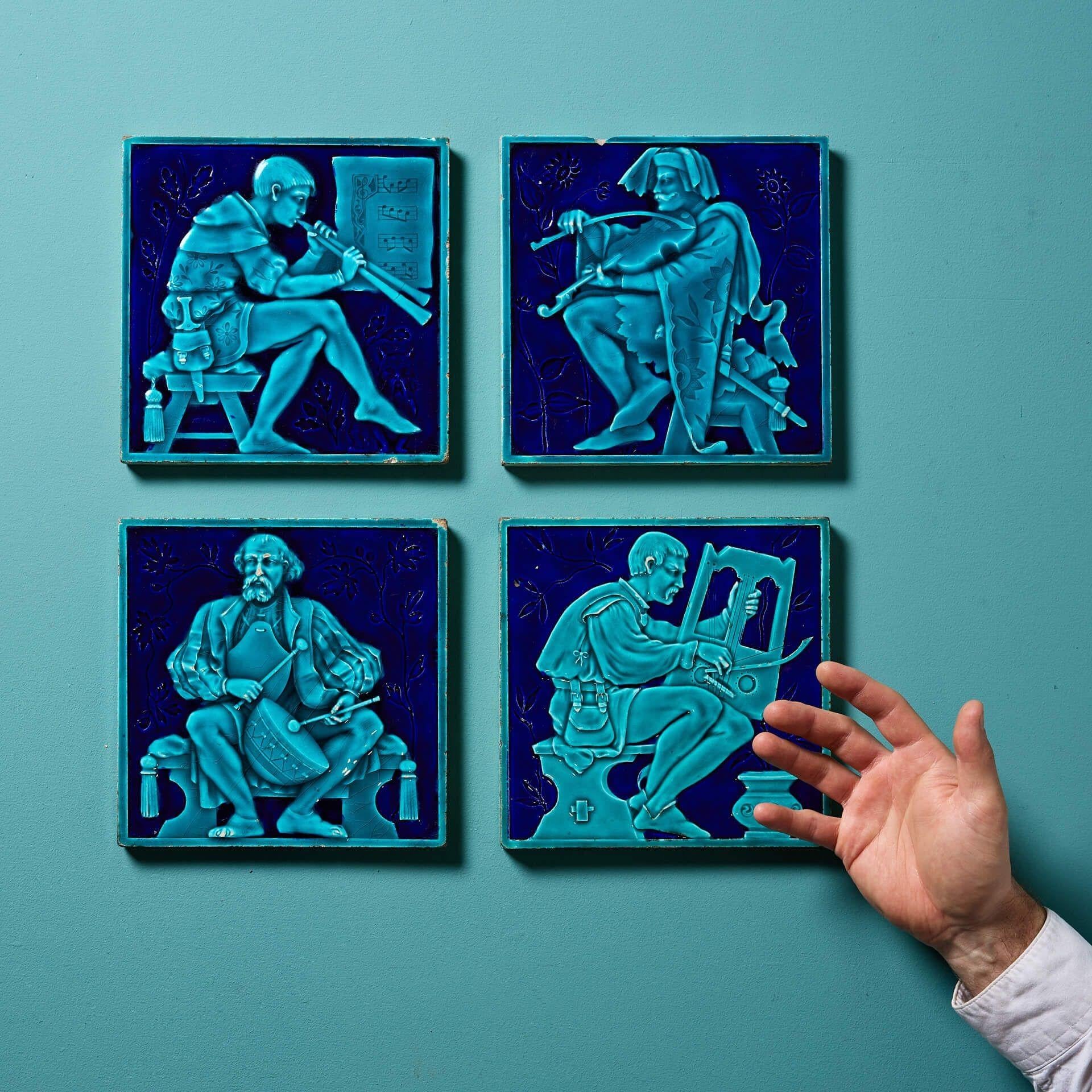 A set of four 19th Century Mintons tile attributed to the artist Edward Hammond.

Modelled in relief, each 8-inch tile is decorated with a different musician in medieval dress picked out in turquoise and dark navy blue majolica glaze.

Dating to