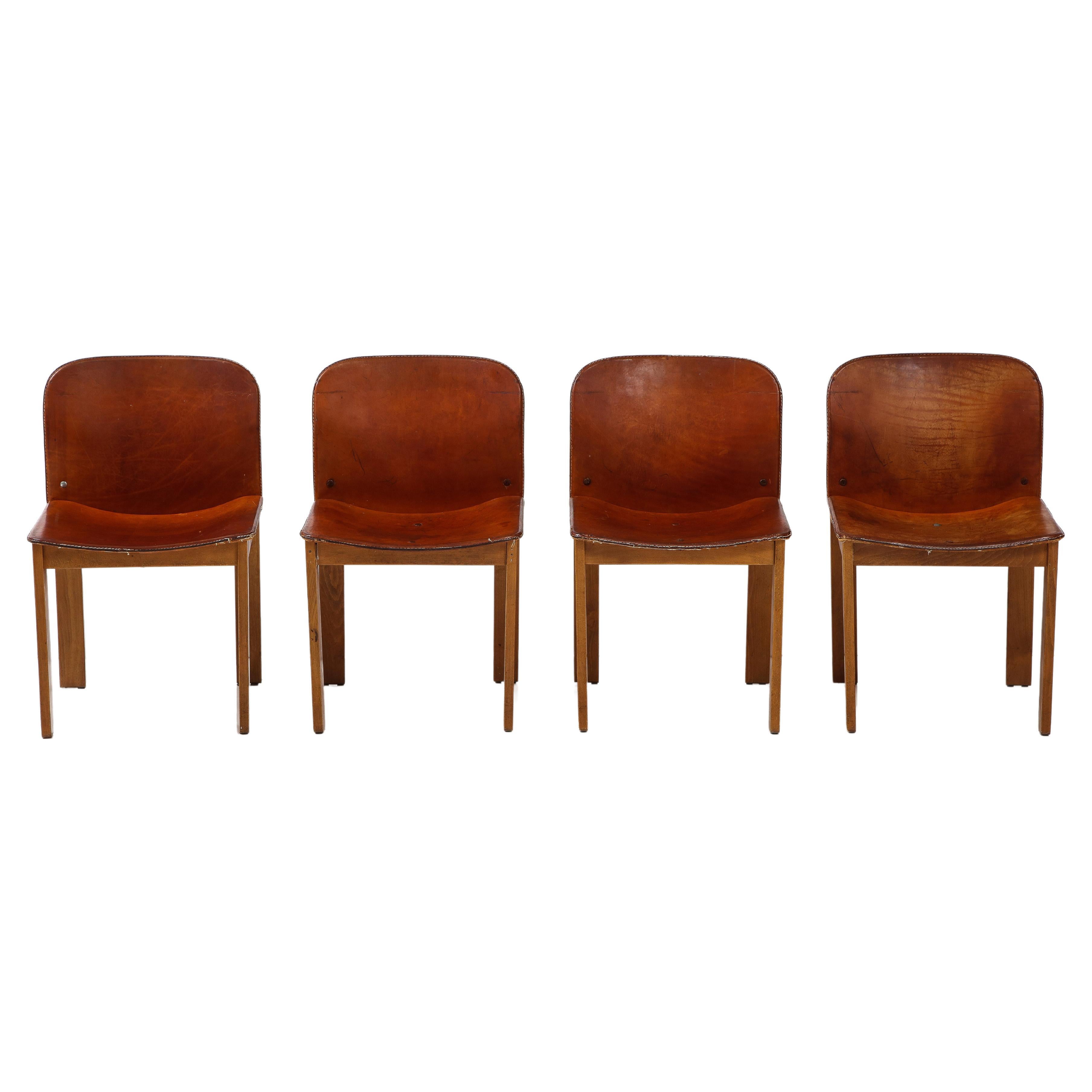 Set of 4 model '121' dining chairs; These chairs have walnut wooden frames and seats and backs covered with cognac colored leather. 
Designed by Afra and Tobia Scarpa and manufactured by Cassina, Italy 1965. 
Size: 31
