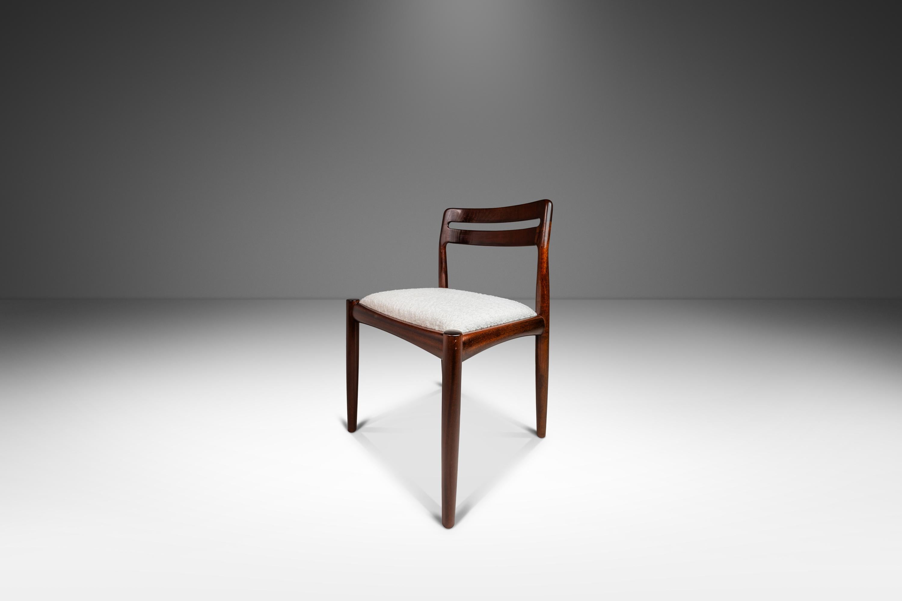 Introducing a rare and limited set of four Model 382 Dining Chairs designed by the influential H.W. Klein for Bramin Møbler. Produced in the mid-1960's this set of Model 382's are constructed from solid mahogany and feature newly upholstered seats